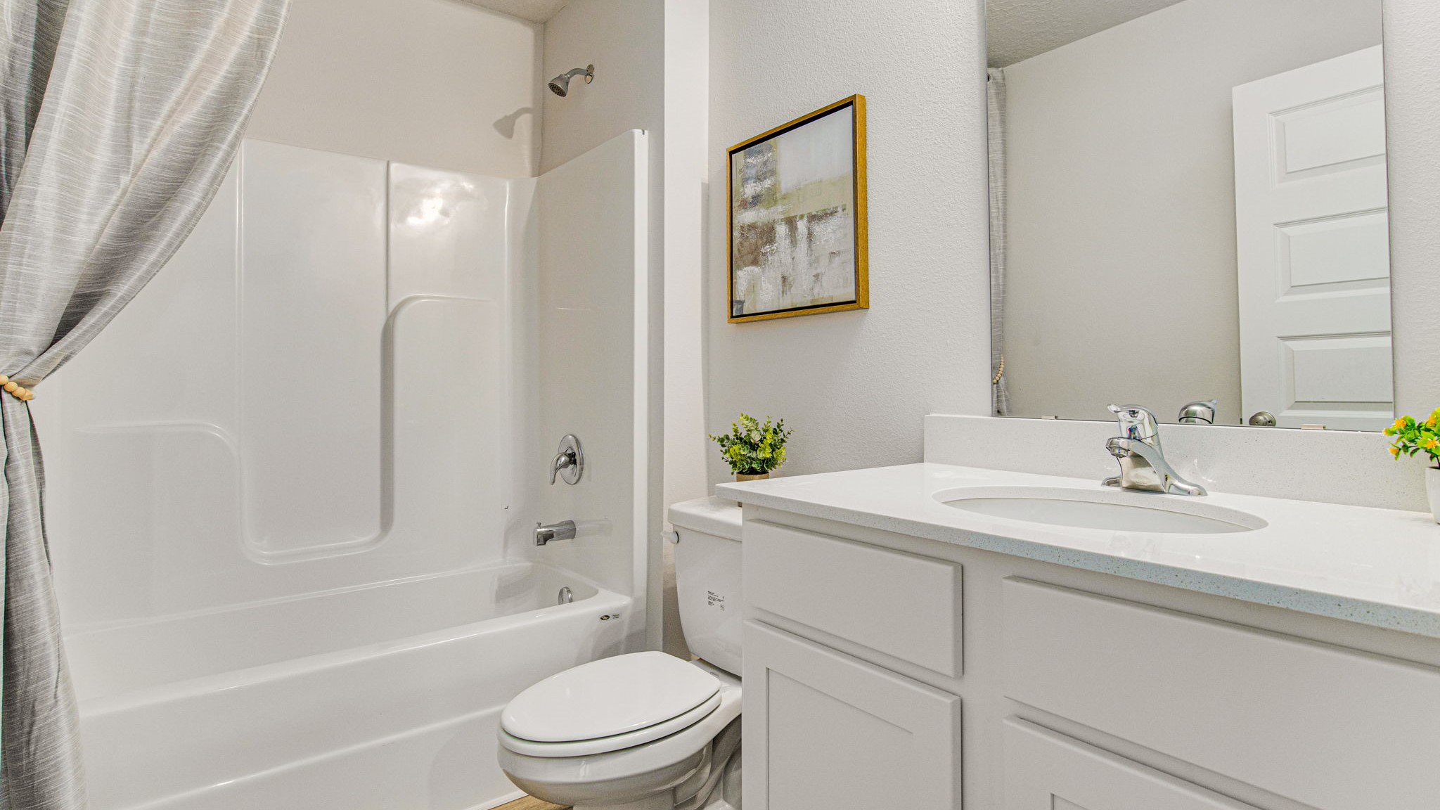 The Lakeside floorplan guest bathroom two with shower and tub combo and quartz countertops