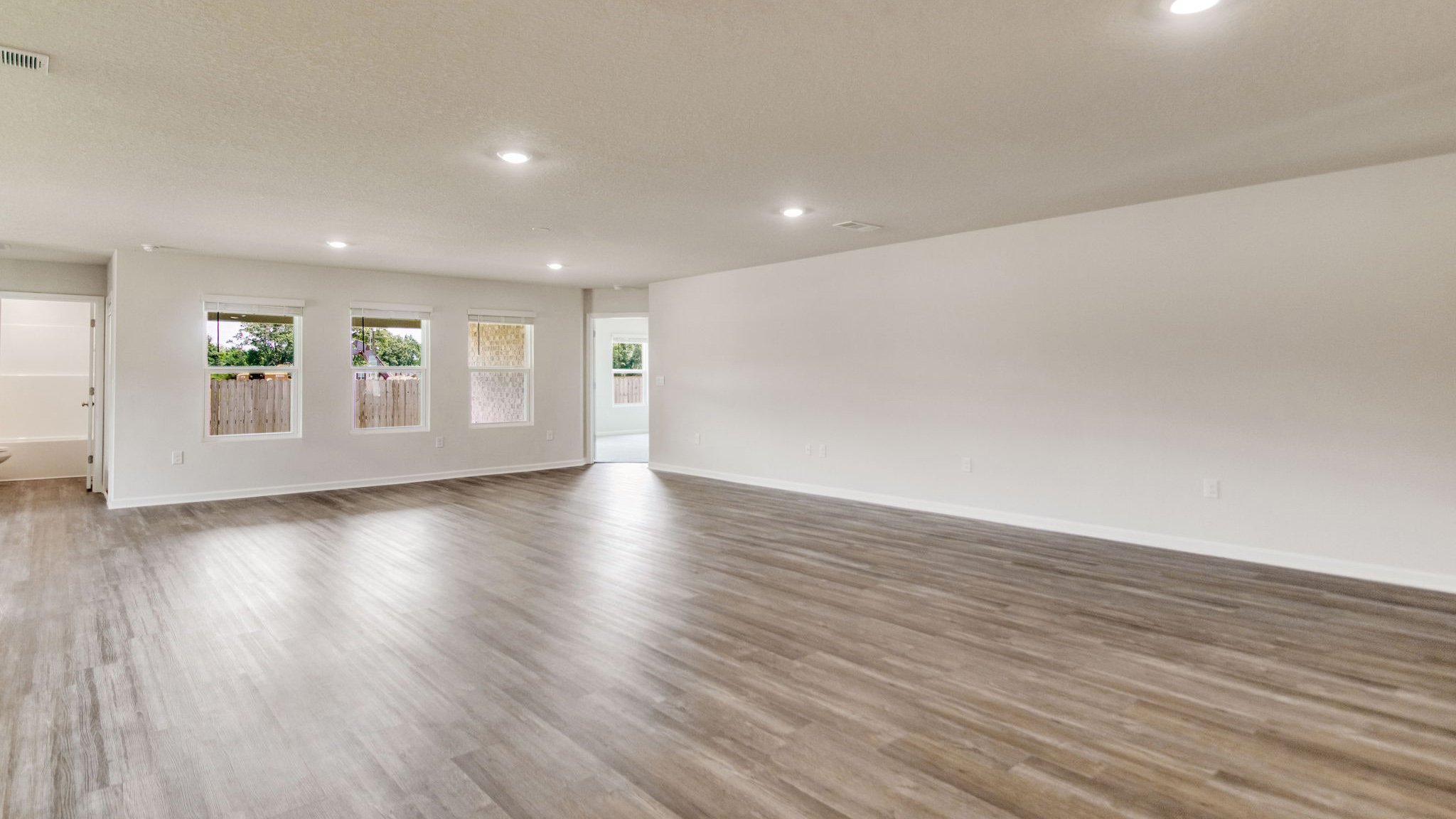 The Sawyer floorplan open concept living room with three windows