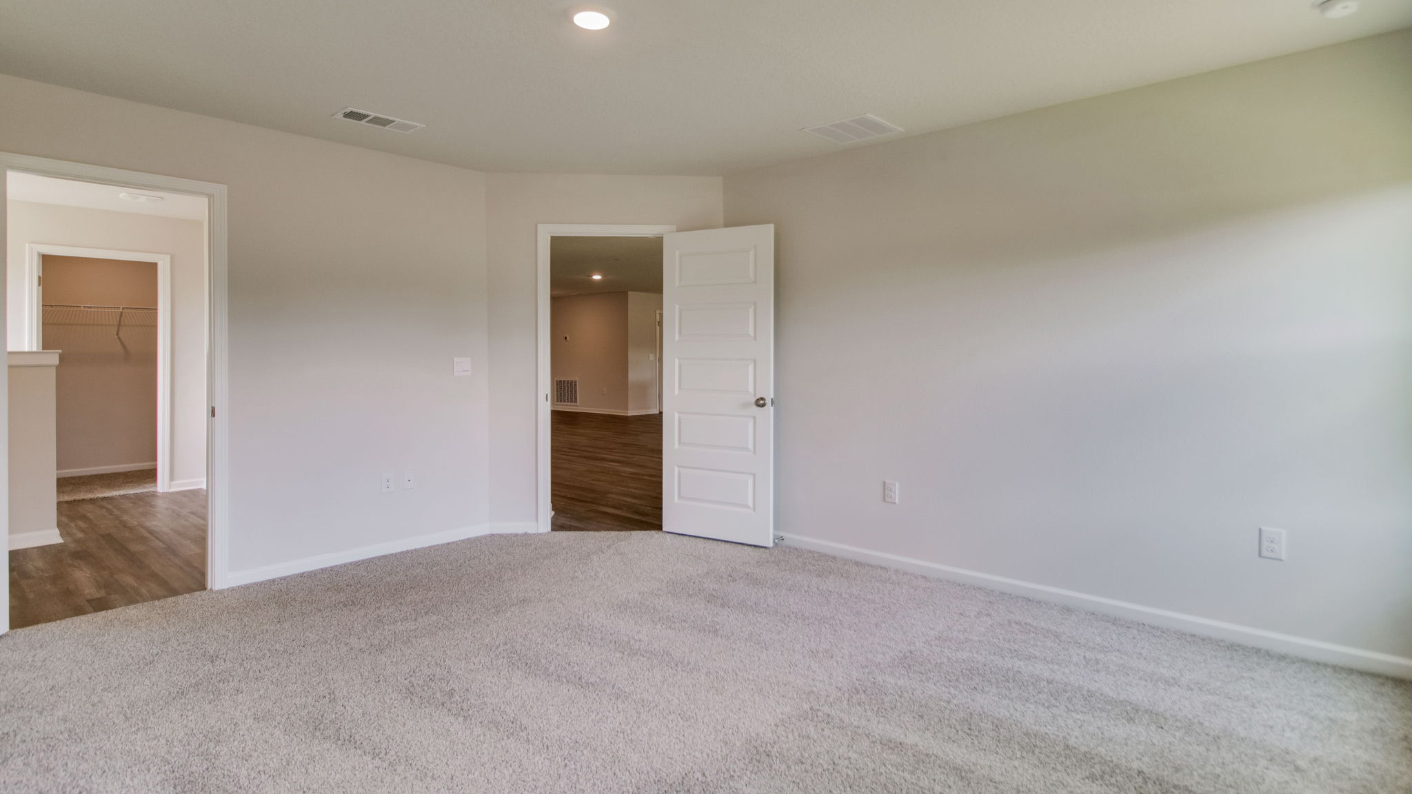 The Sawyer floorplan primary bedroom with carpet throughout
