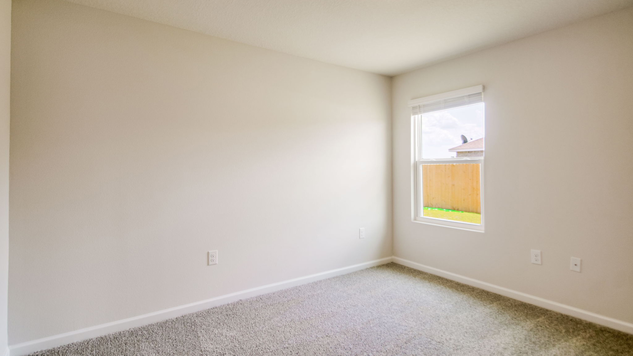 The Sawyer floorplan guest bedroom two with carpet throughout