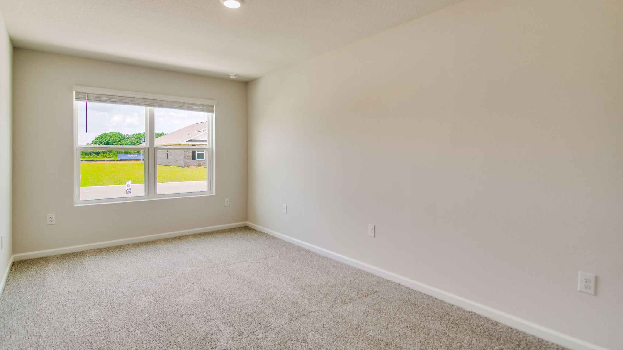 The Sawyer floorplan guest bedroom three with carpet throughout
