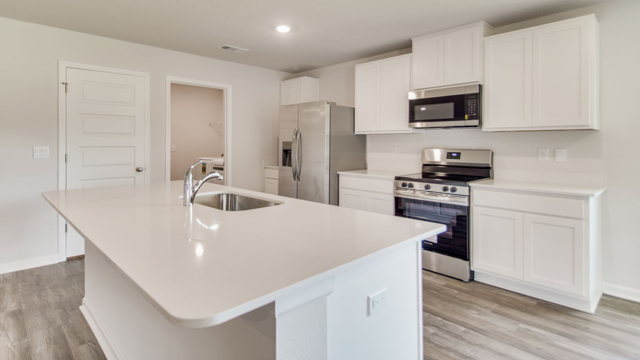 The Sawyer floorplan kitchen with white shaker cabinets and stainless-steel appliances