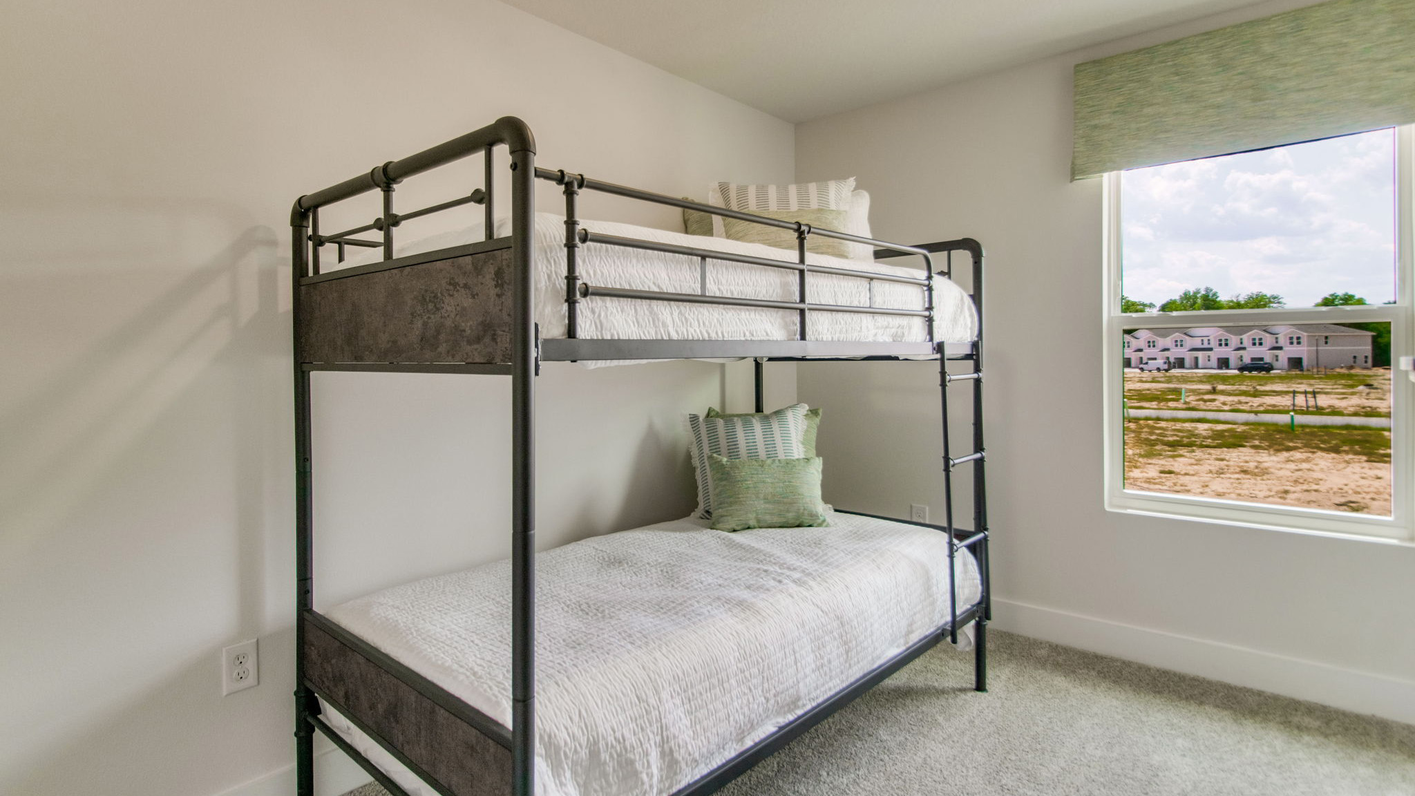 The Palm floorplan guest bedroom one with carpet throughout