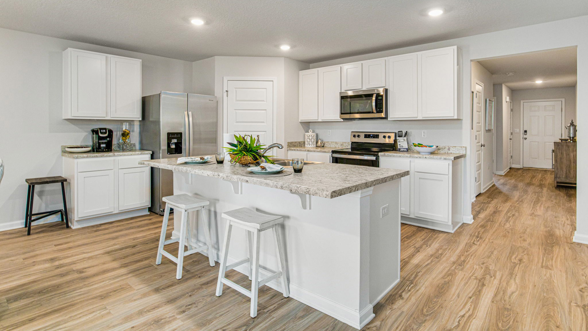 The Cali floorplan kitchen with white shaker cabinets and Formica countertops