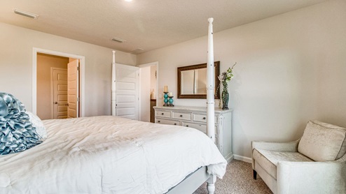 Cali model primary bedroom with bathroom view
