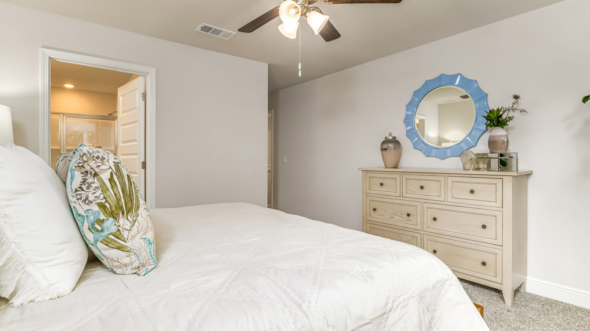 The Sabal floorplan primary bedroom with large window and carpet throughout