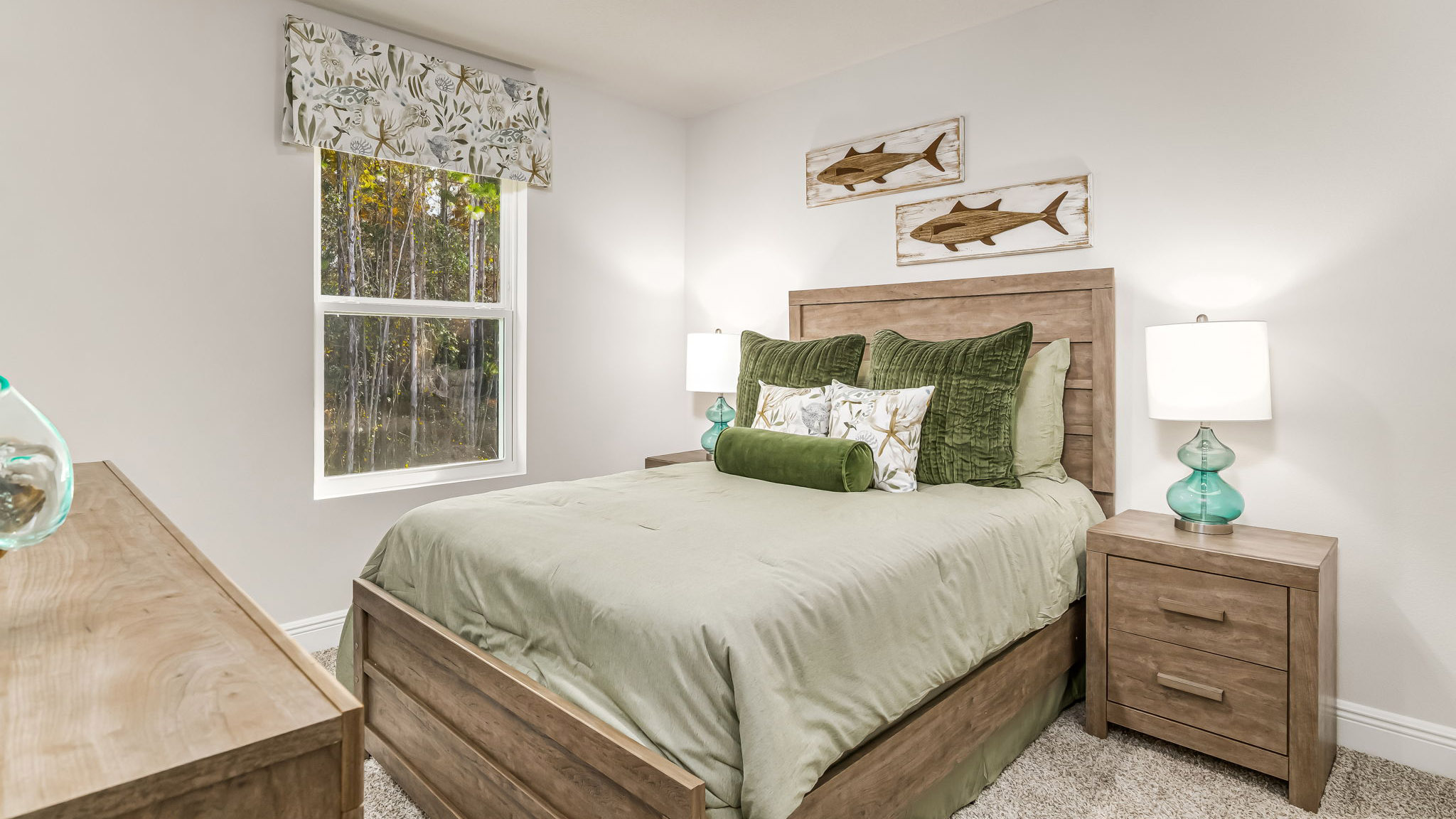 The Sabal floorplan guest bedroom one with carpet throughout