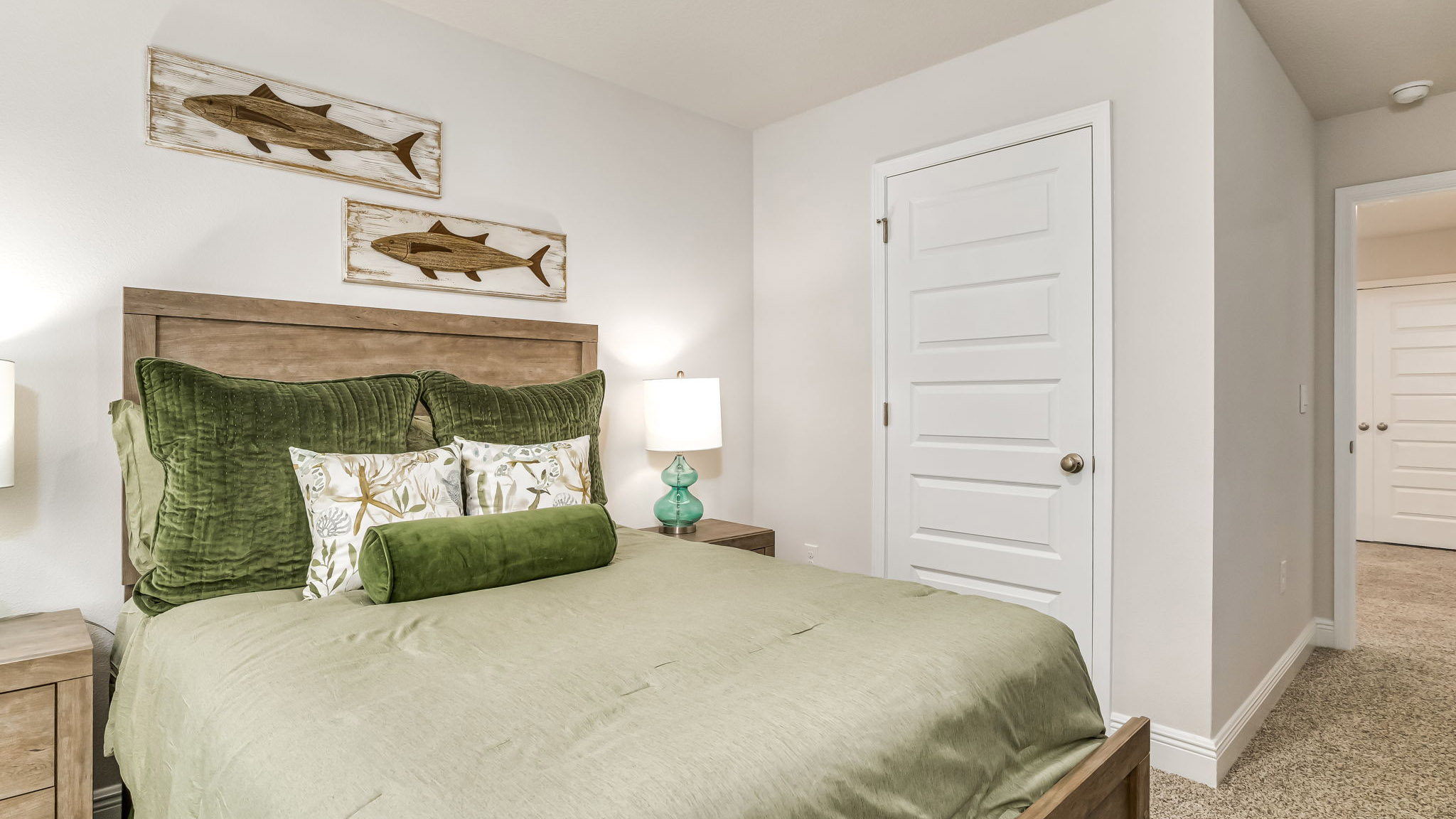 The Sabal floorplan guest bedroom one with carpet throughout