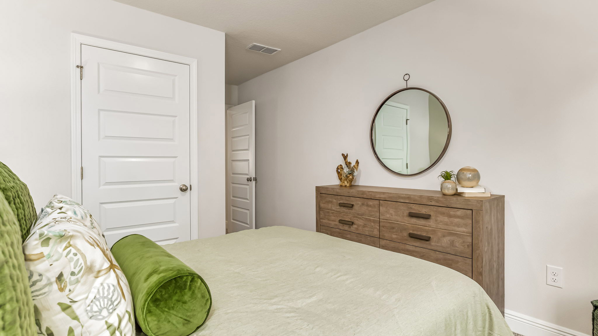 The Sabal floorplan guest bedroom one with carpet throughout