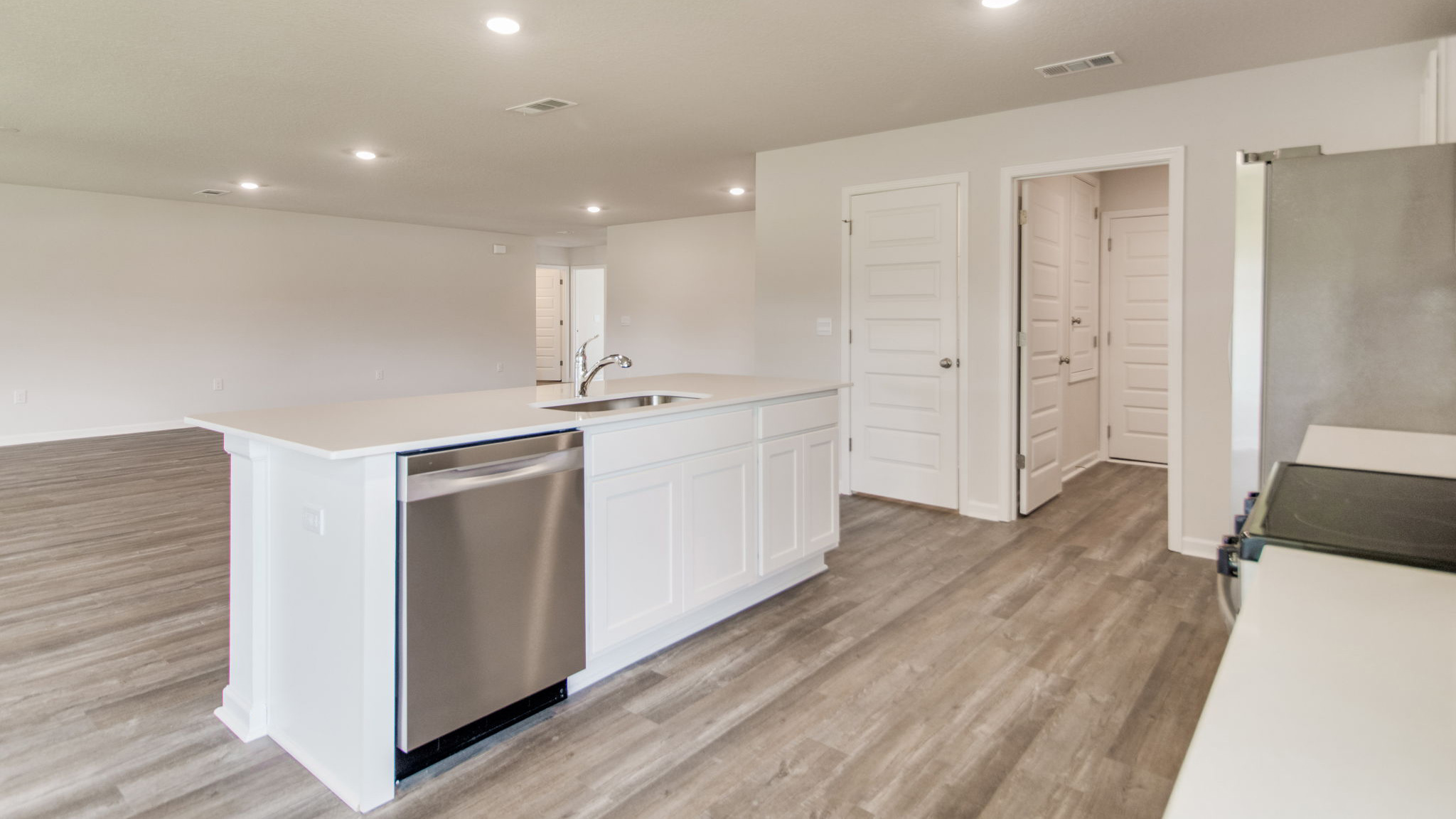 The Sawyer floorplan kitchen island with stainless-steel appliances