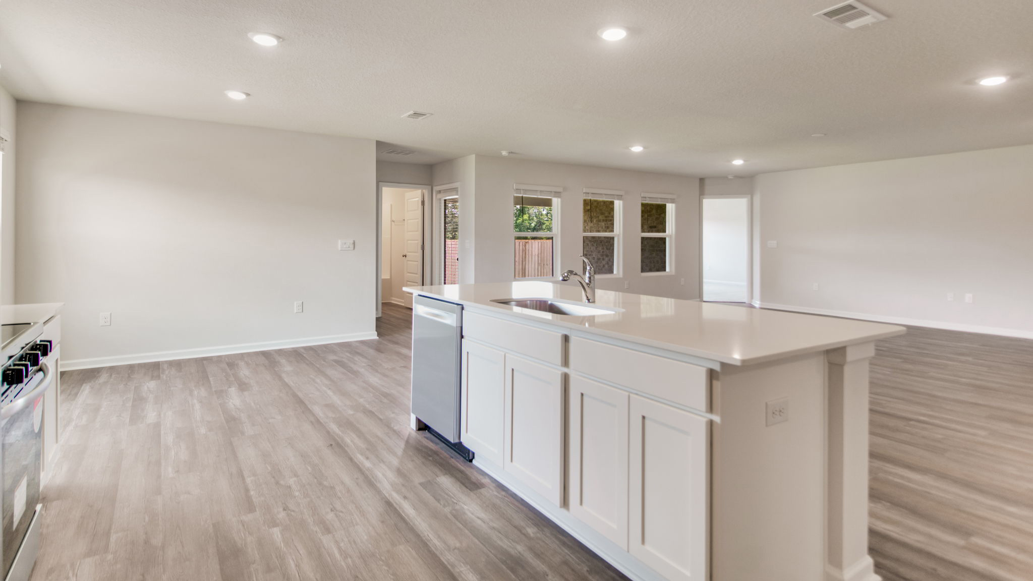 The Sawyer floorplan kitchen island with white shaker cabinets and stainless-steel appliances