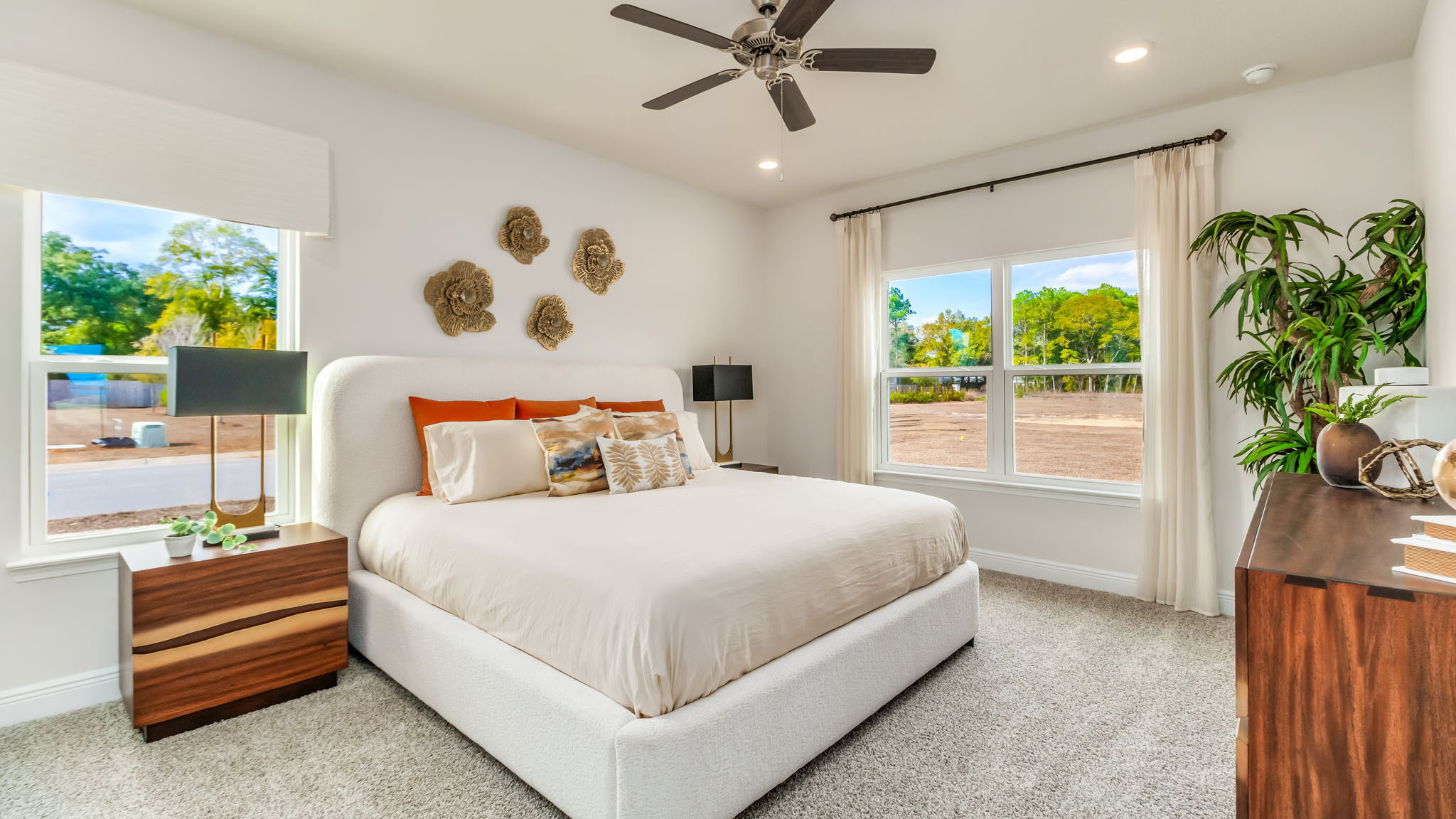 The Belfort floorplan primary bedroom with carpet throughout and natural light from windows