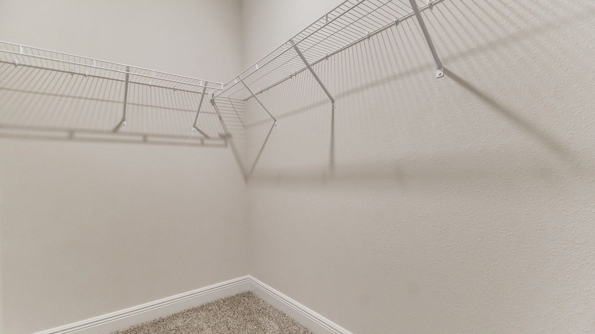 The Belfort floorplan primary closet with wire shelving