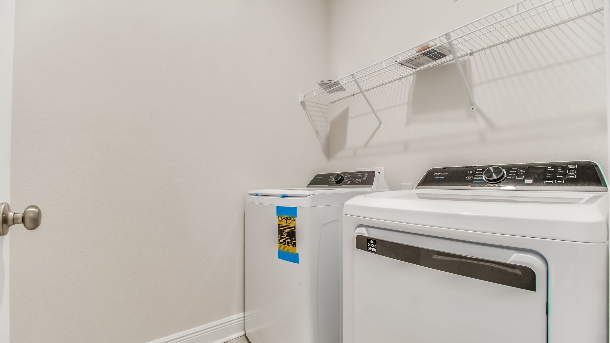The Belfort floorplan laundry room located near the kitchen with EVP throughout