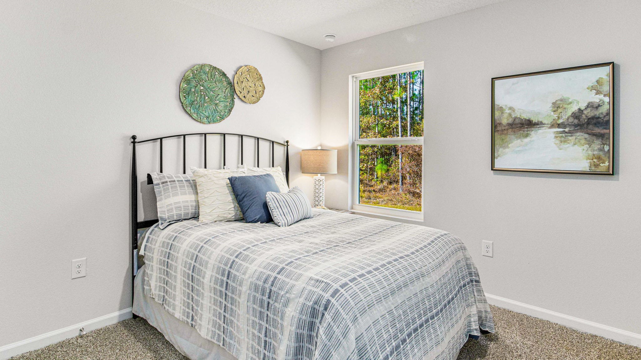 The Cali floorplan guest bedroom one with window view