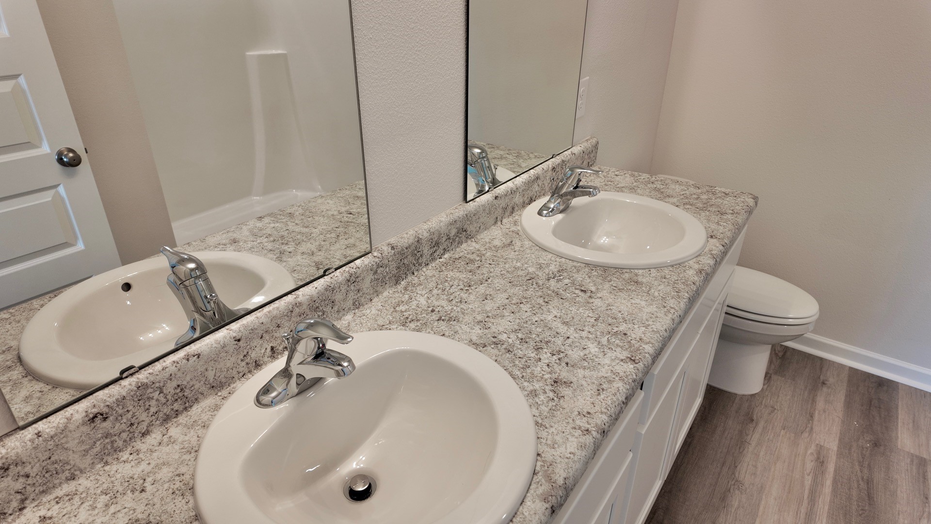 The Lismore floorplan primary bathroom with dual vanity and Formica countertops