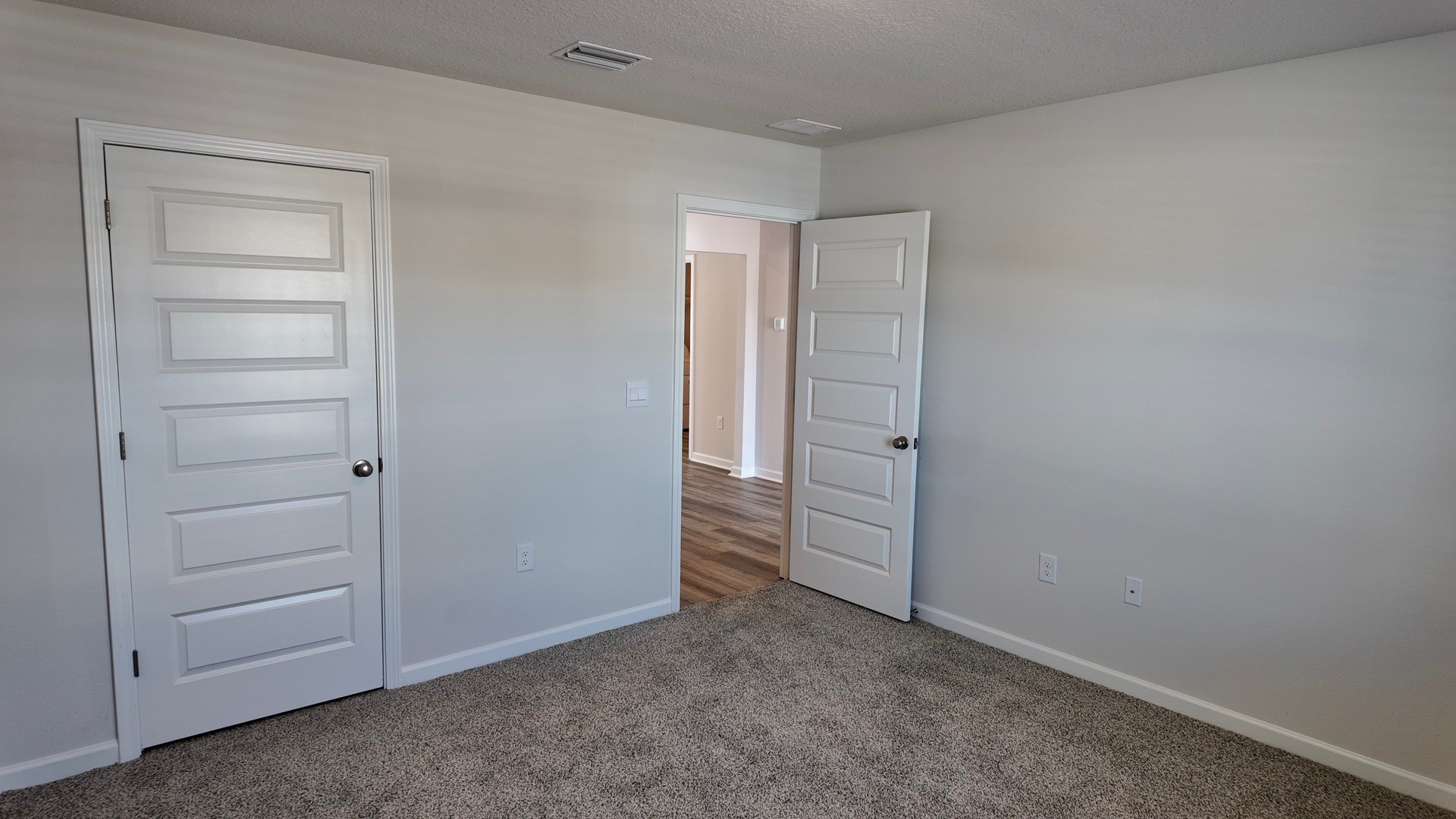 The Lismore floorplan guest bedroom one with carpet throughout