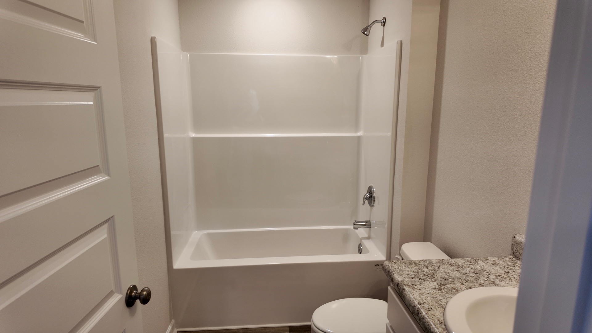 The Lismore floorplan guest bathroom with single vanity and Formica countertops