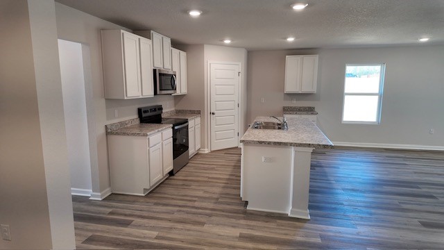 The Lakeside floorplan kitchen with white shaker cabinets and Formica countertops