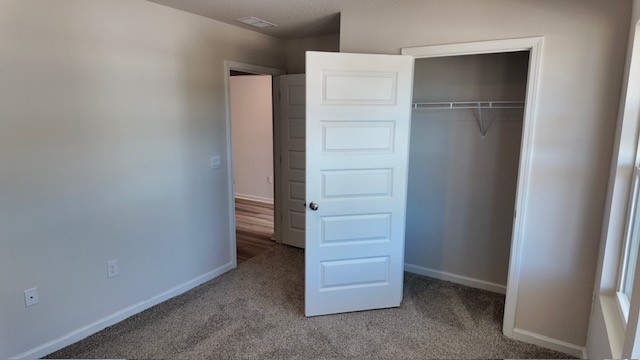 The Lakeside floorplan guest bedroom two with carpet throughout