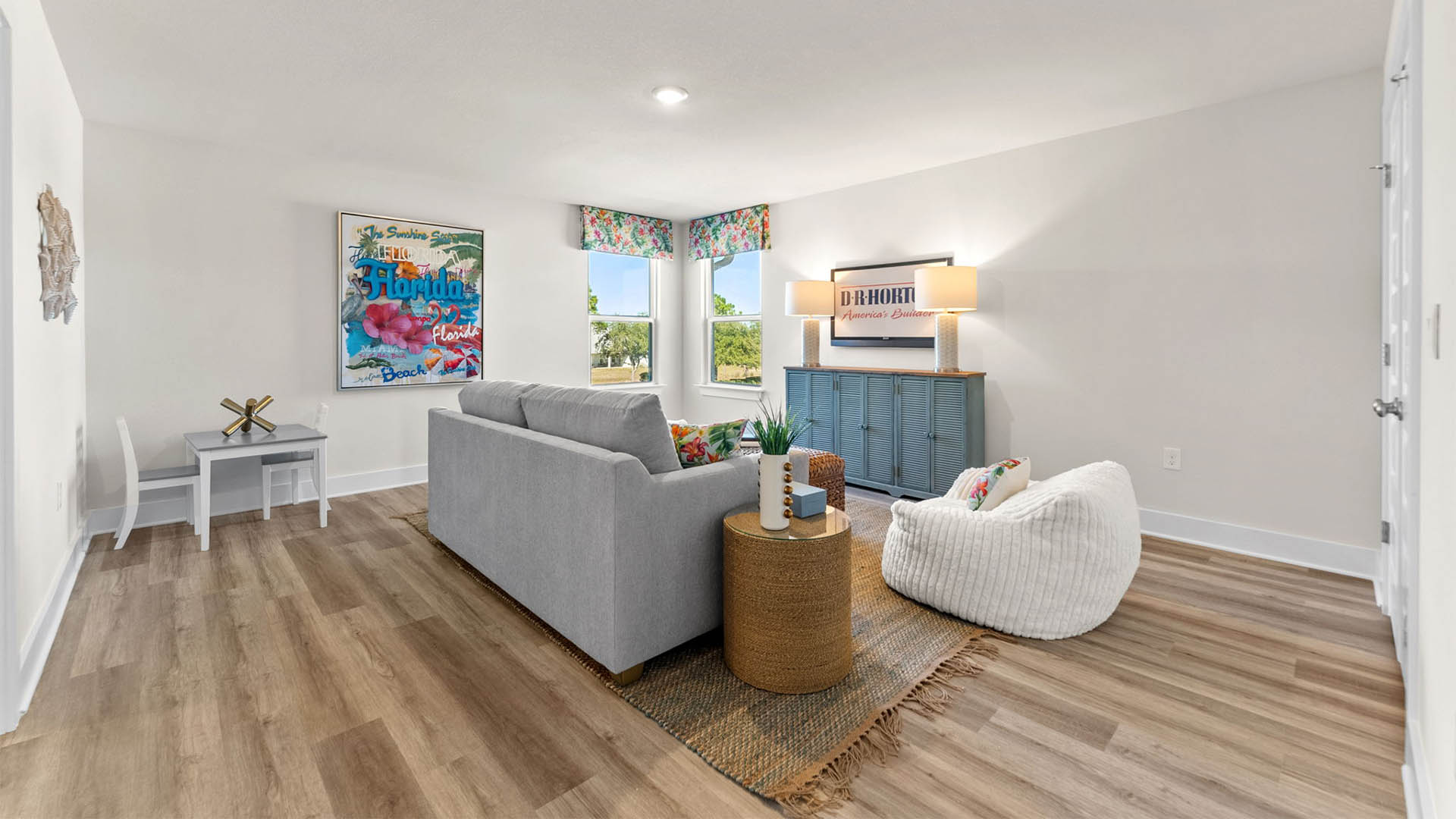 Upstairs common area with window and bedroom entrances.