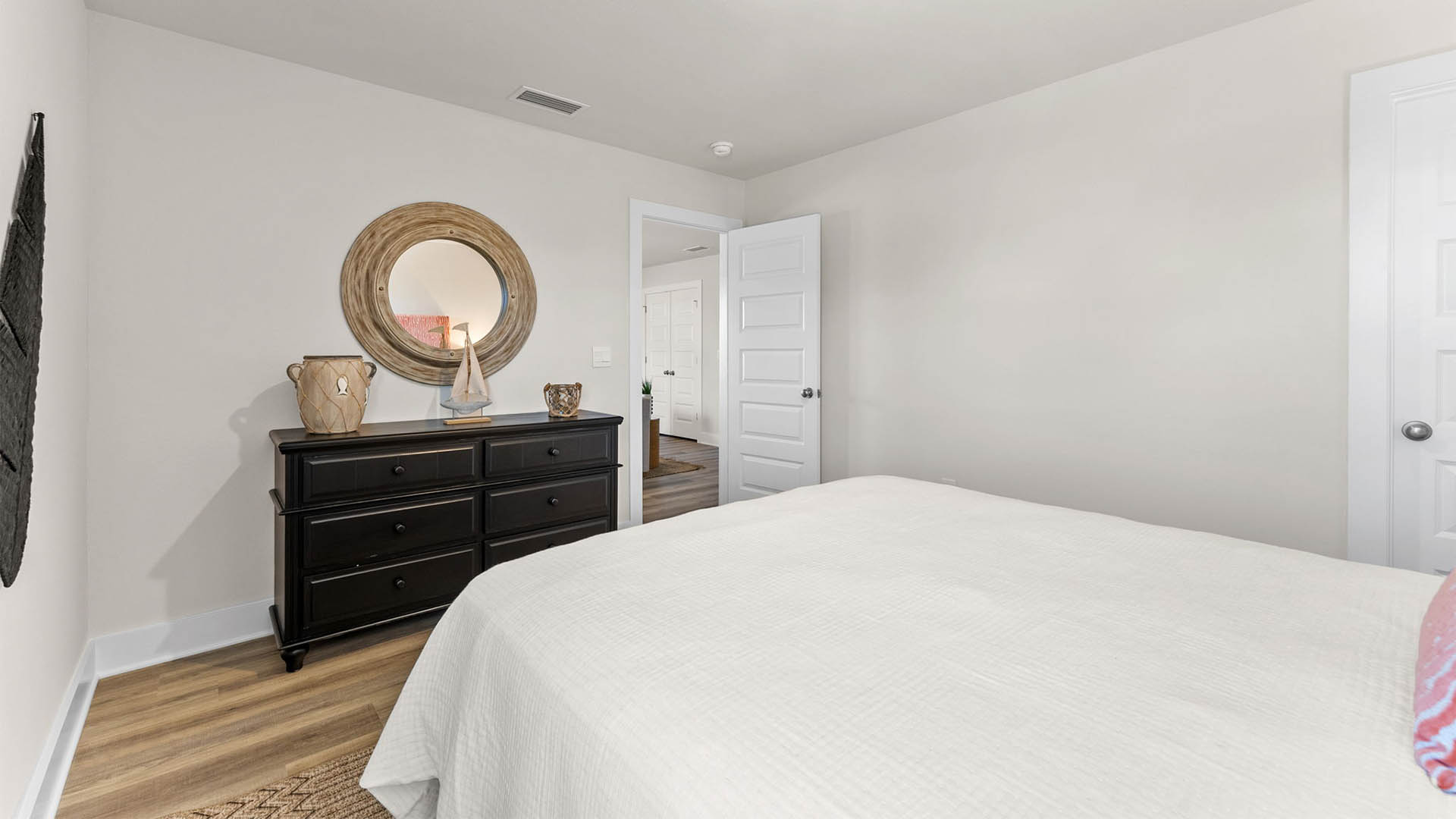 Bedroom with EVP flooring and closet.