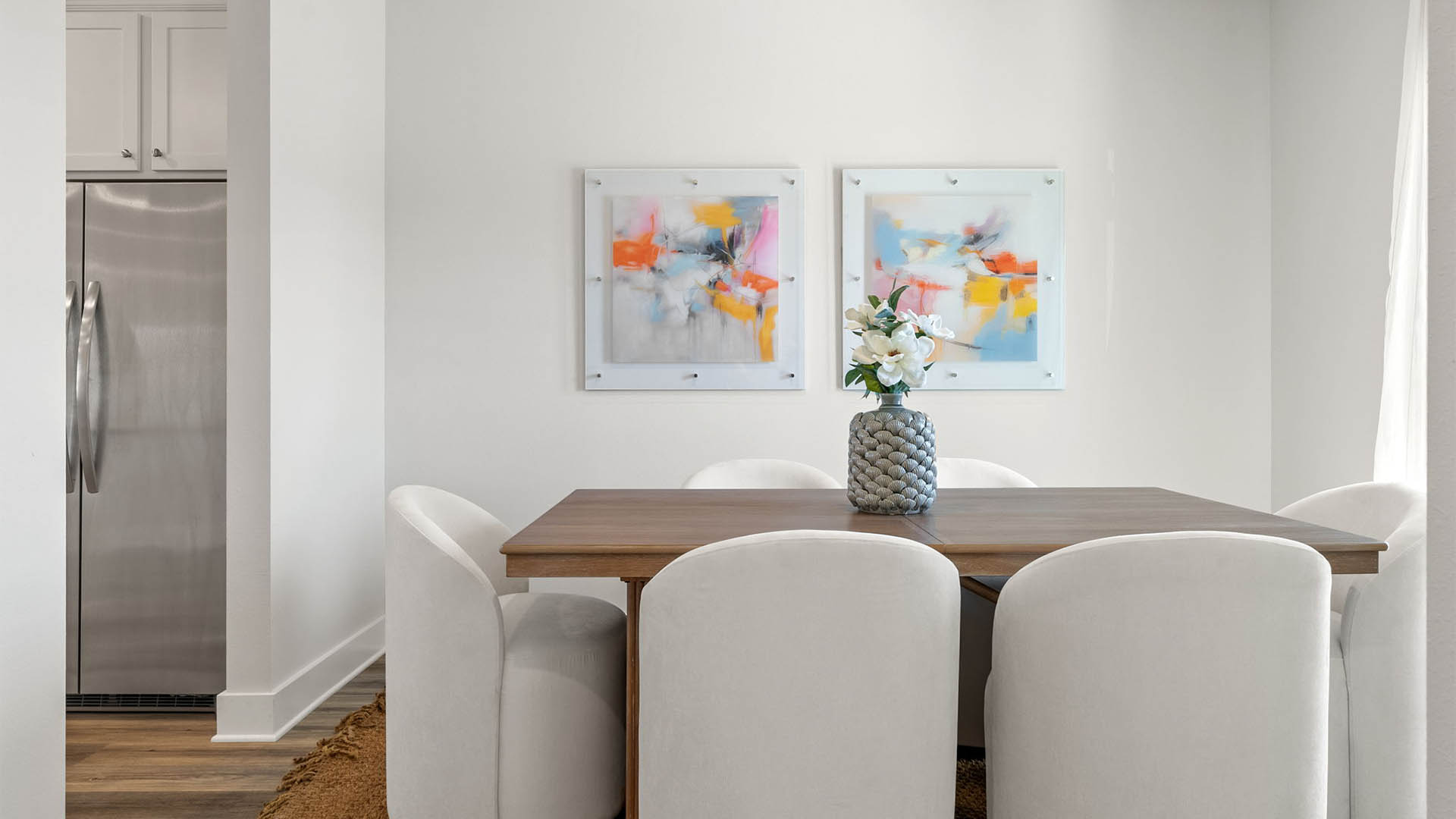 Dining room with EVP flooring and window.
