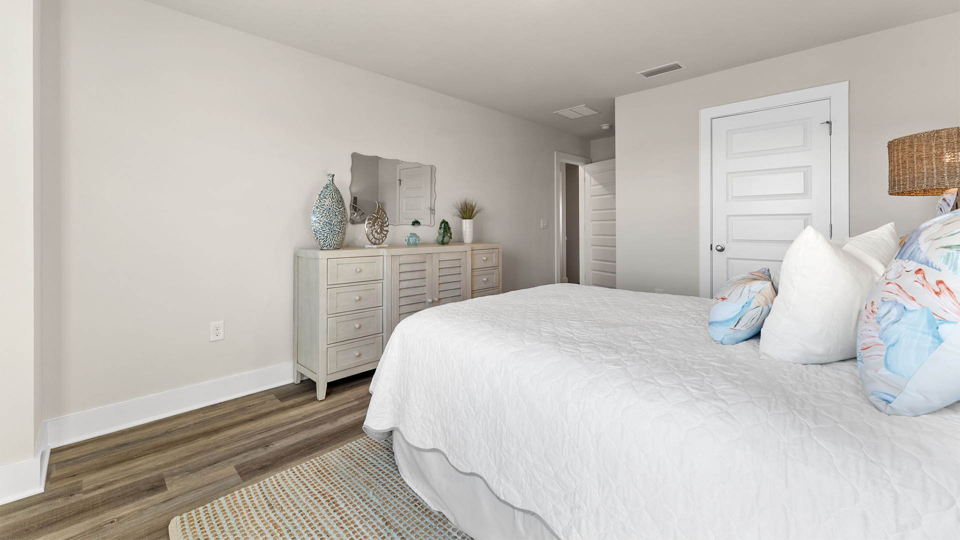 Bedroom with EVP flooring and closet.