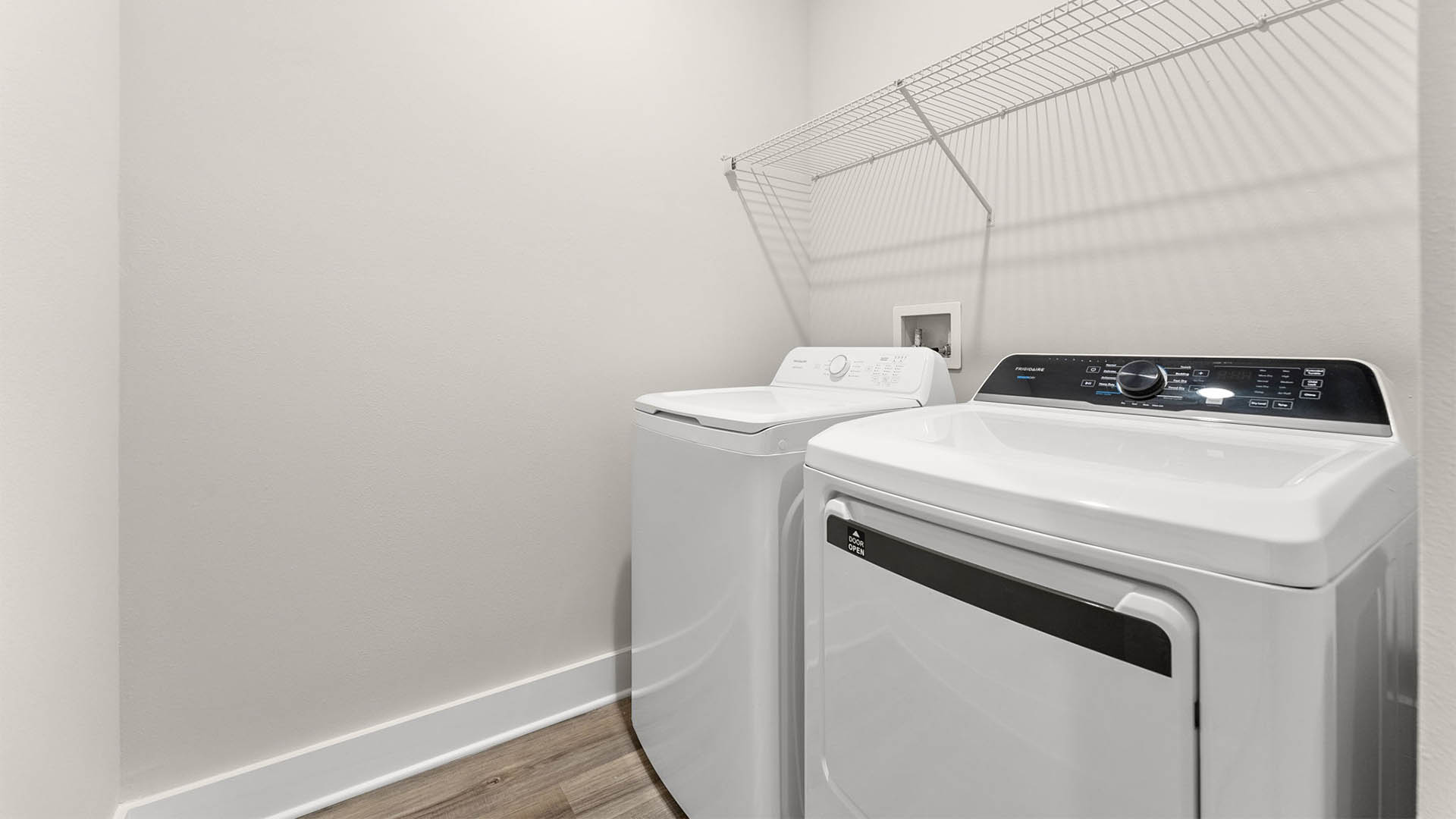 Laundry room with EVP flooring and ventilated shelving.