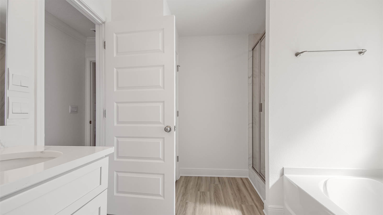 Primary bathroom shower with tile and tub.