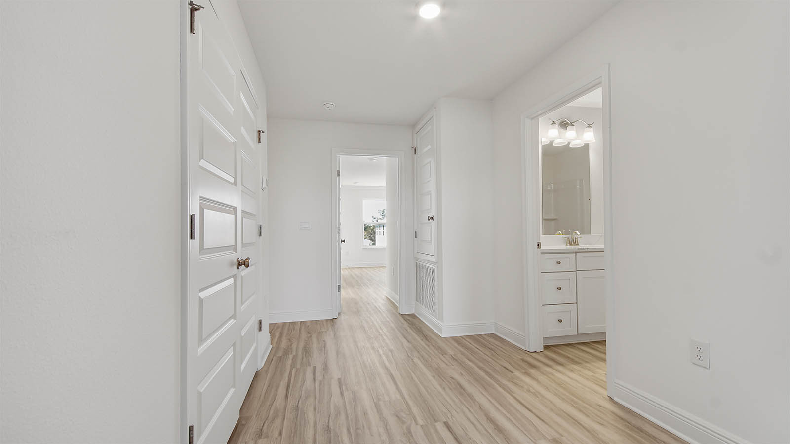 Hallway with EVP flooring and bathroom and bedroom entrances.
