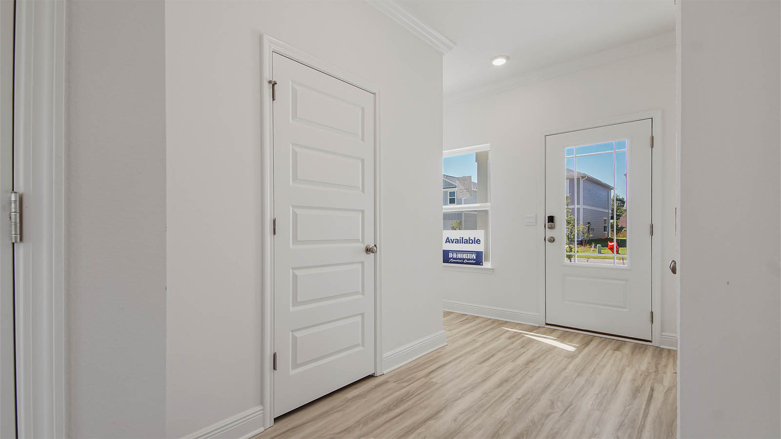 Front foyer with EVP flooring and closet.