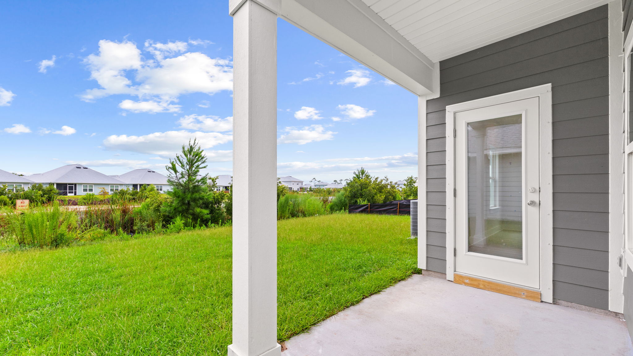Covered back patio and back yard view.