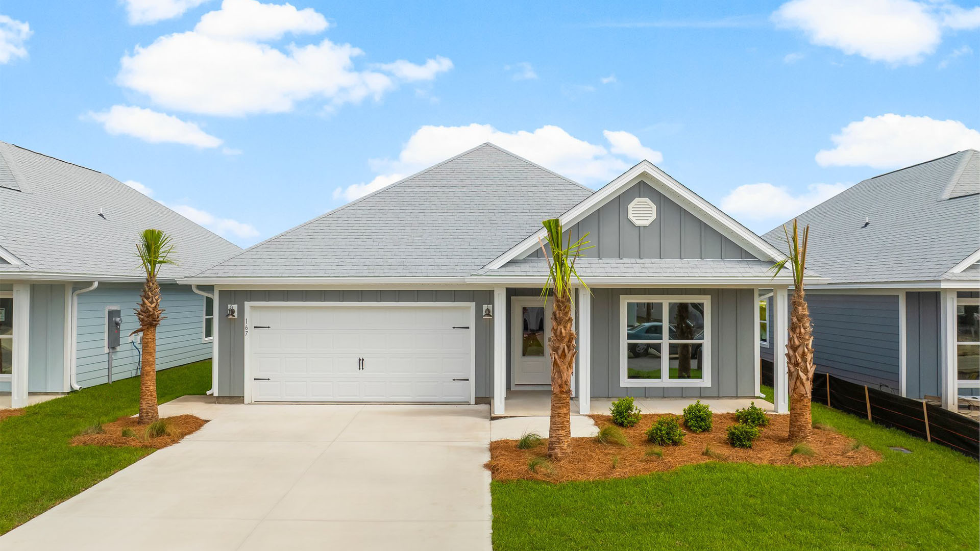 Rhett floor plan at WindMark Beach front of home with Hardie Board siding and two-car garage and covered front porch.