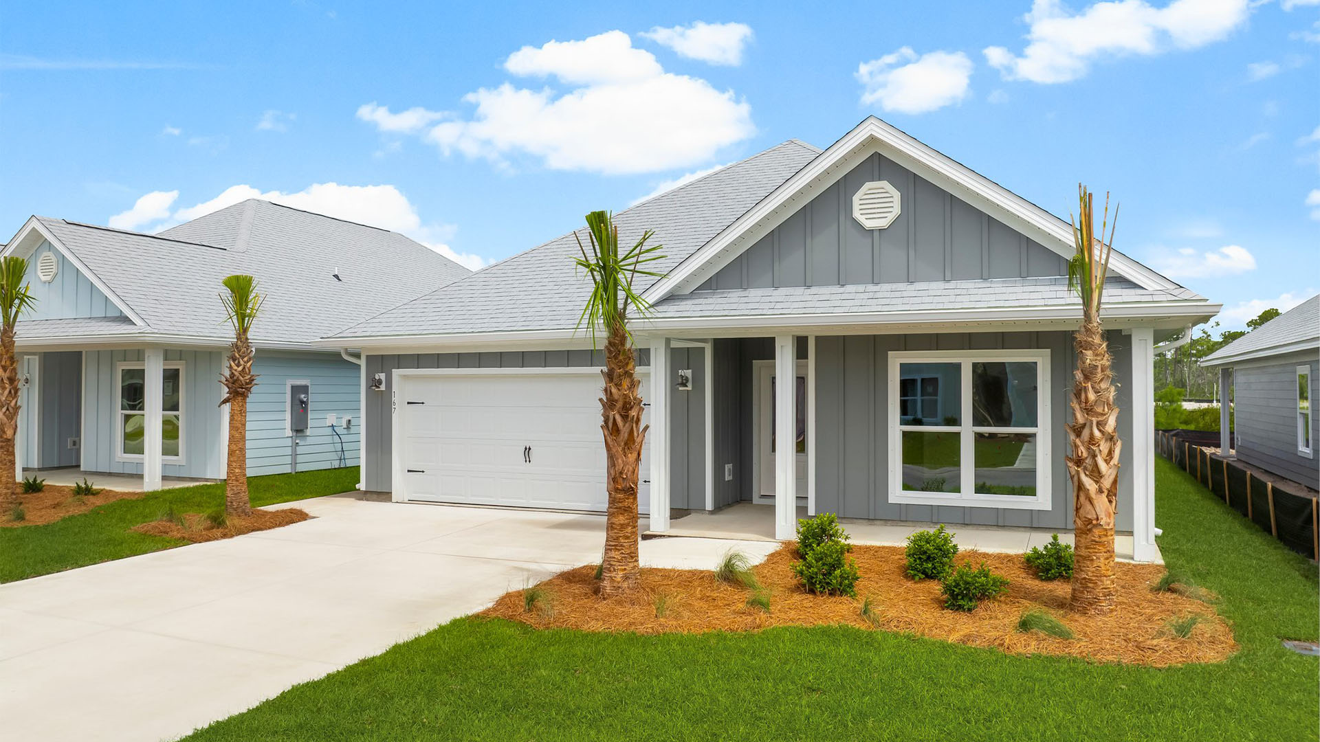 Rhett floor plan at WindMark Beach front of home with Hardie Board siding and two-car garage and covered front porch.