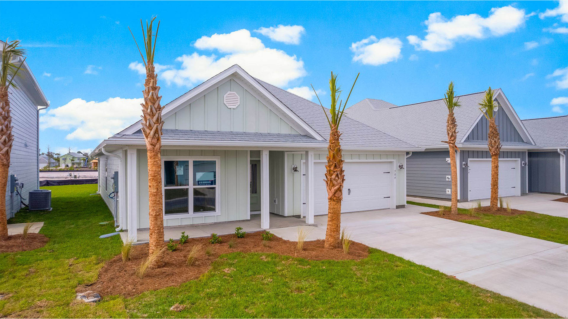 Rhett floor plan at WindMark Beach front of home with Hardie Board siding and two-car garage and covered front porch.