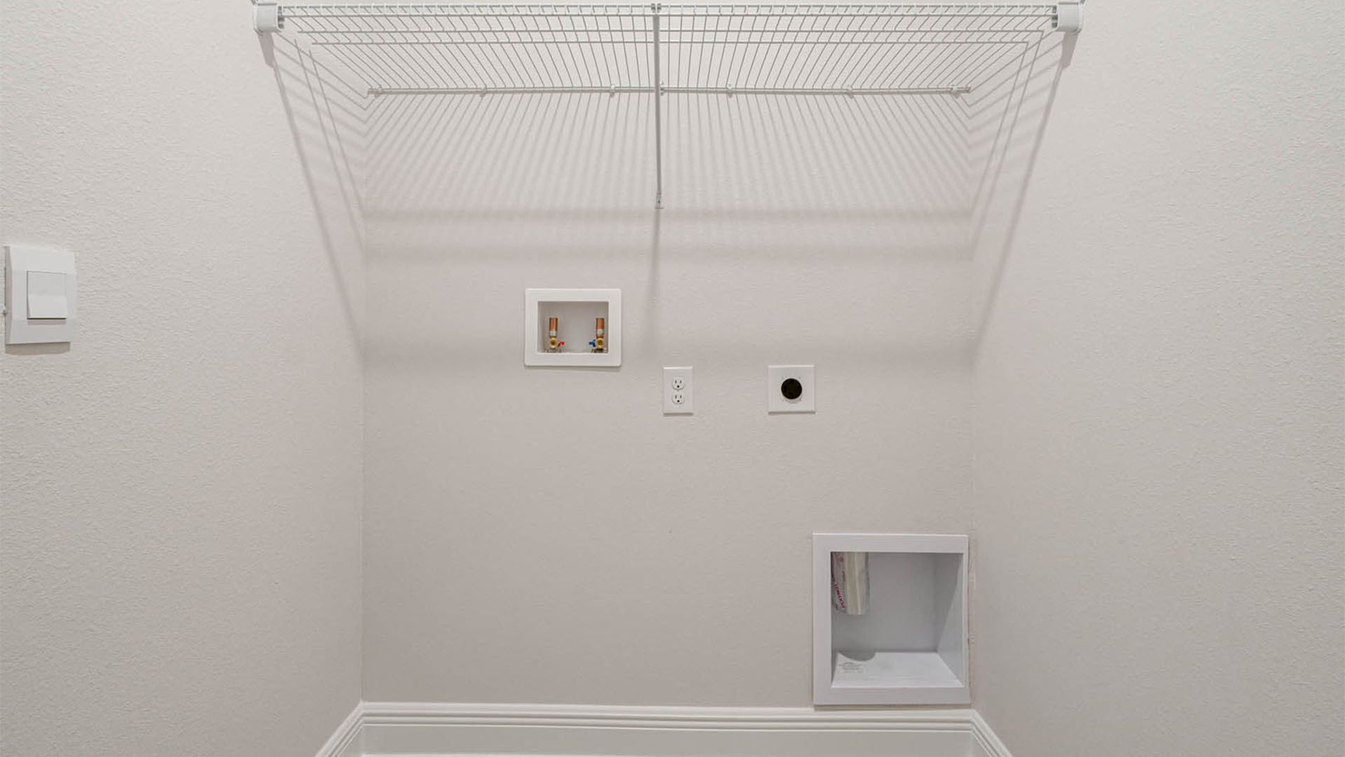 Laundry room with ventilated shelving.