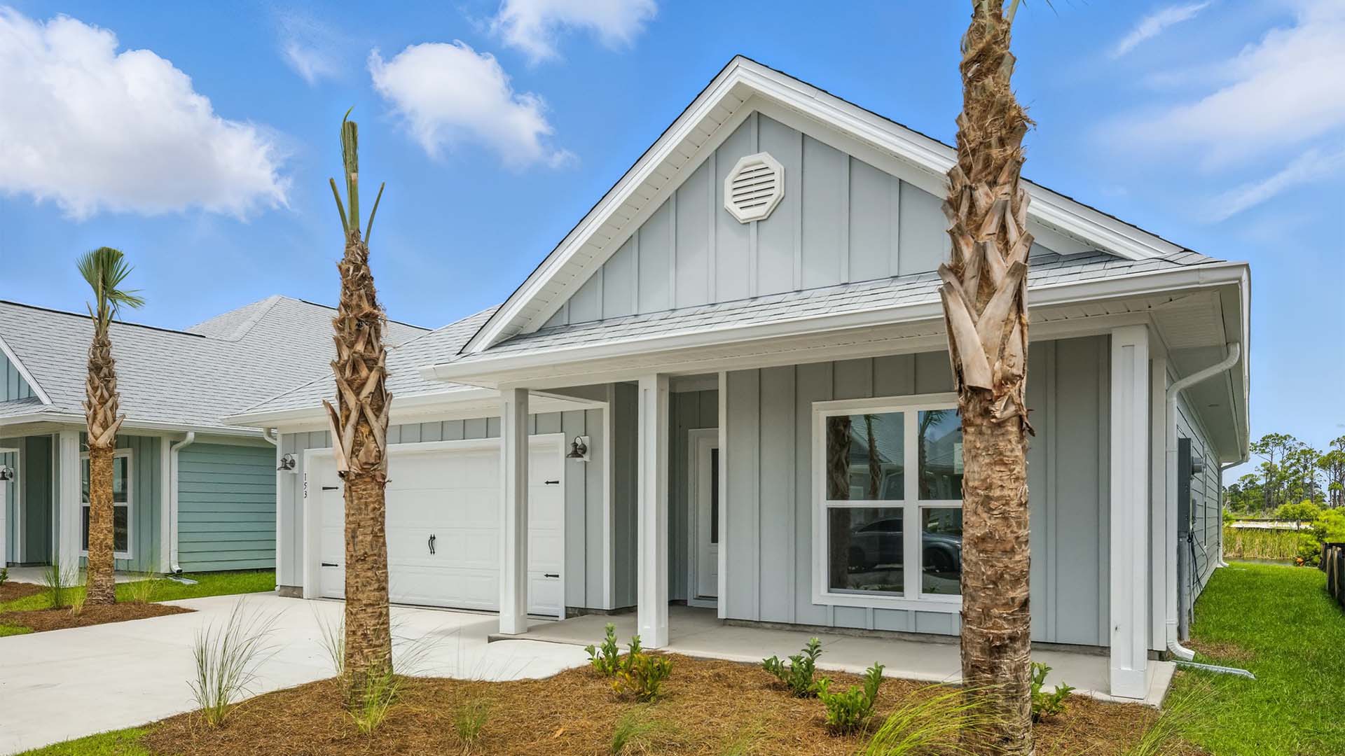 Rhett floor plan at WindMark Beach front of home with Hardie Board siding and two-car garage and covered front porch.