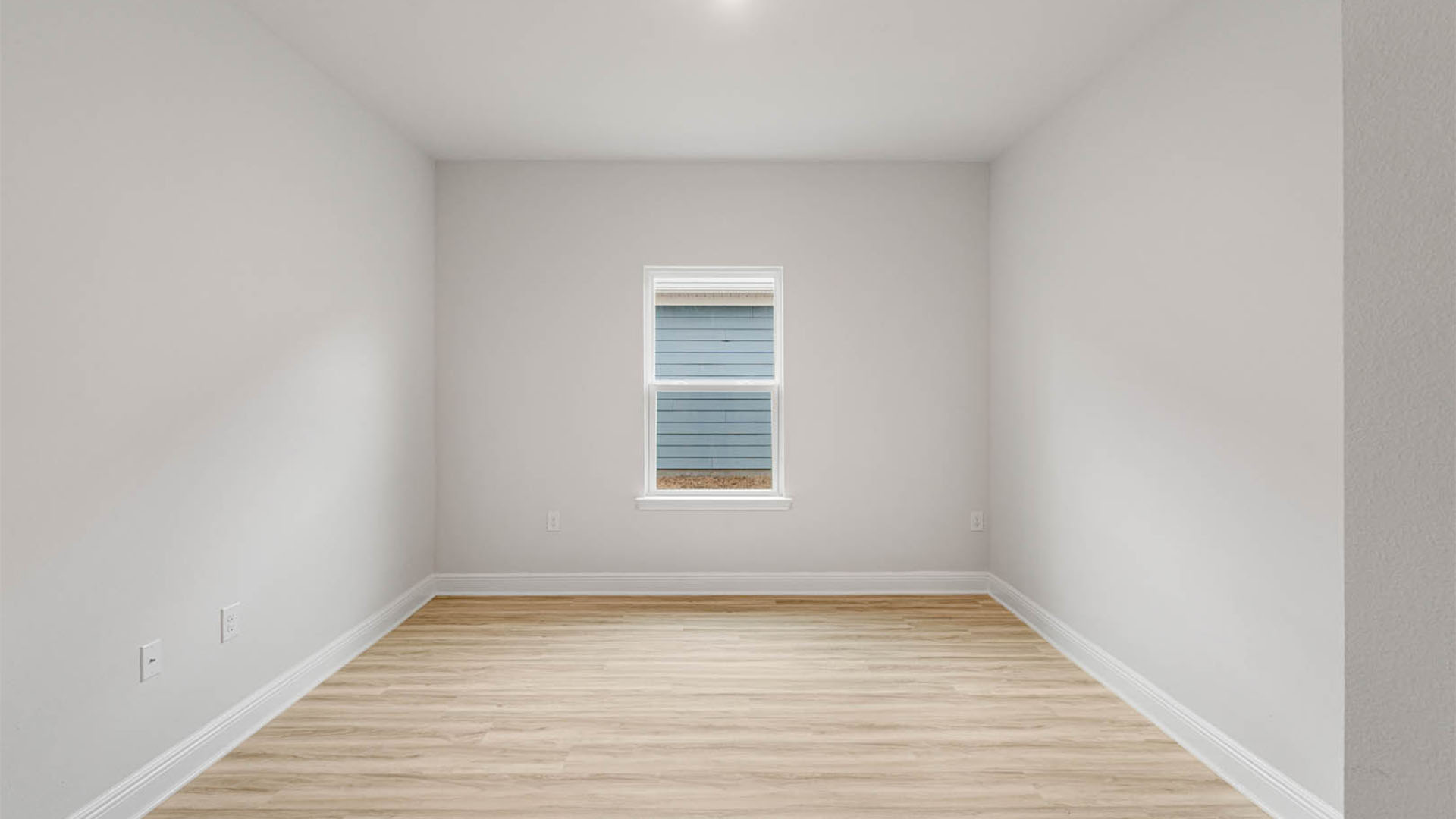 Bedroom with EVP flooring and window.