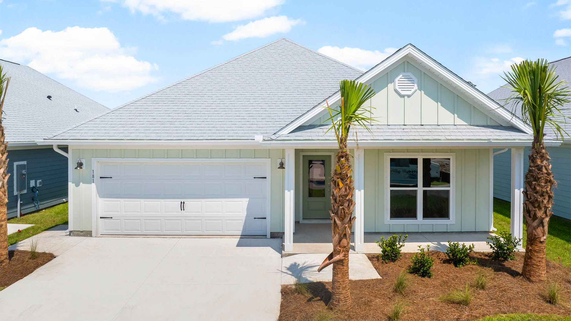 Rhett floor plan at WindMark Beach front of home with Hardie Board siding and two-car garage and covered front porch.