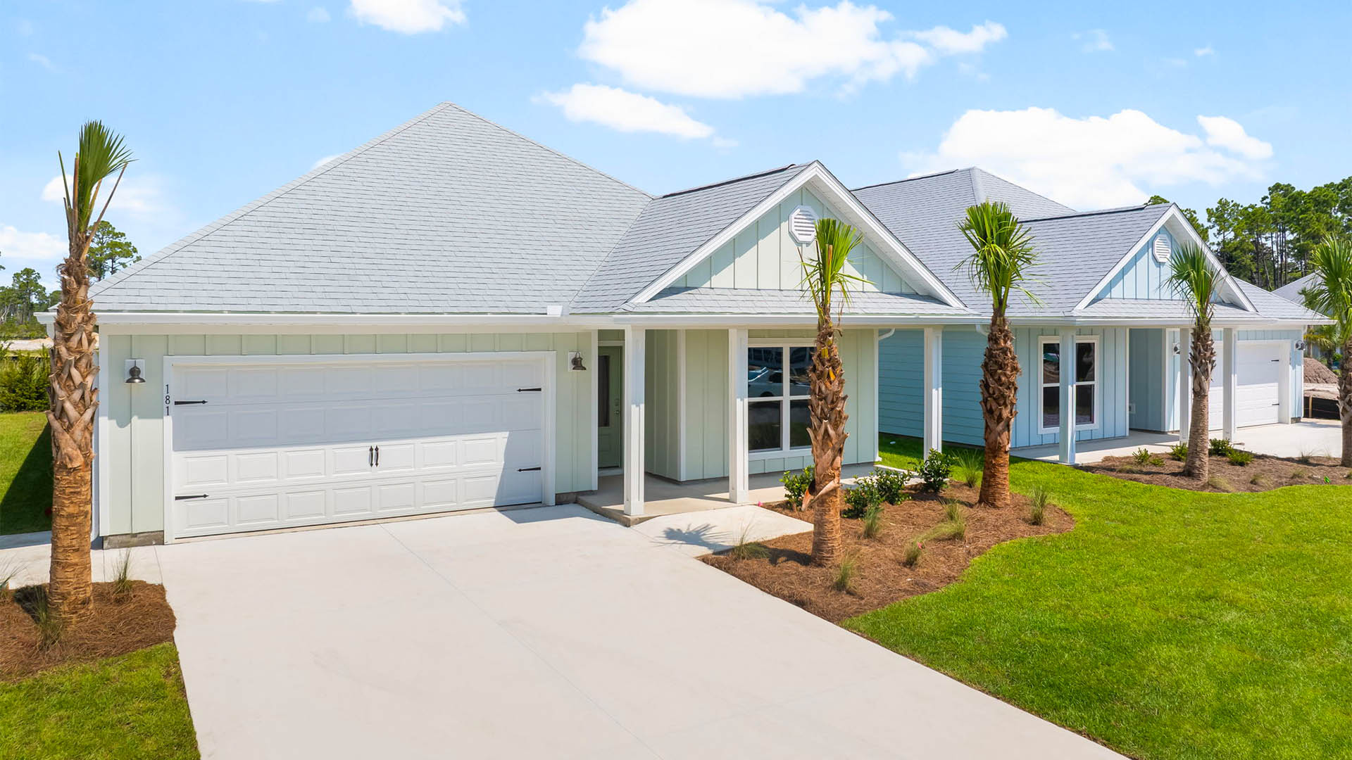 Rhett floor plan at WindMark Beach front of home with Hardie Board siding and two-car garage and covered front porch.