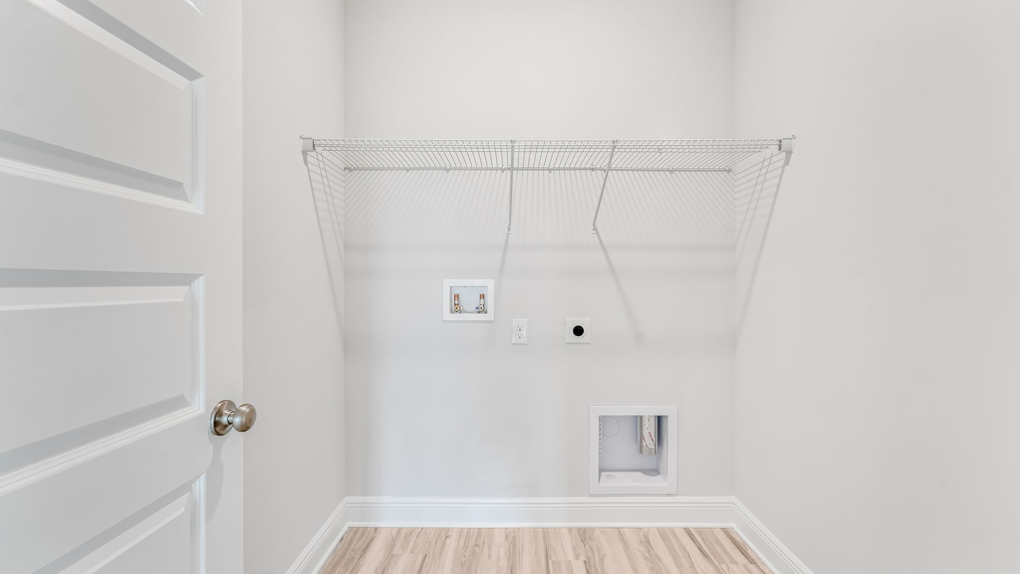 Laundry room with ventilated shelving.