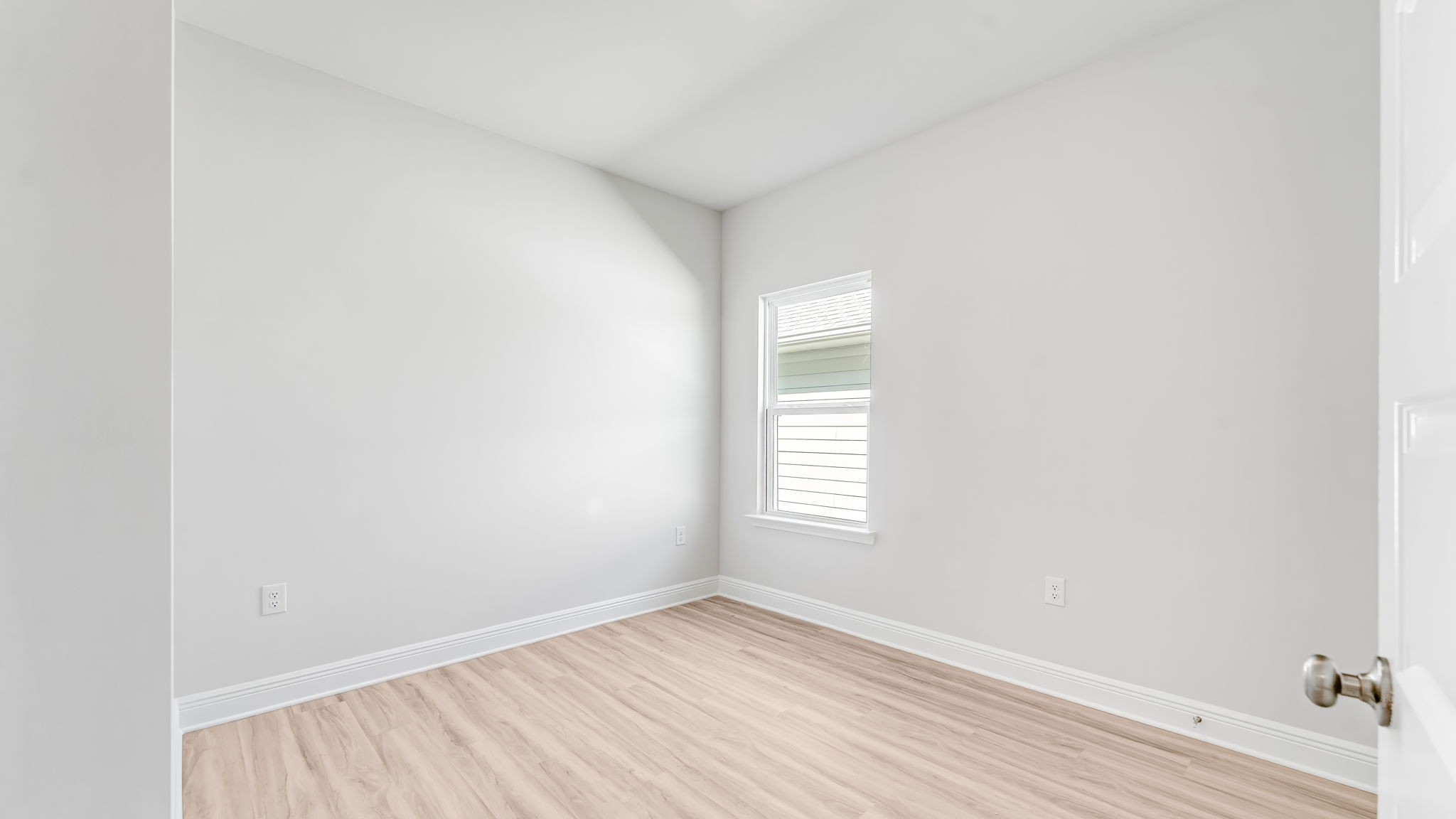 Bedroom with EVP flooring and window.