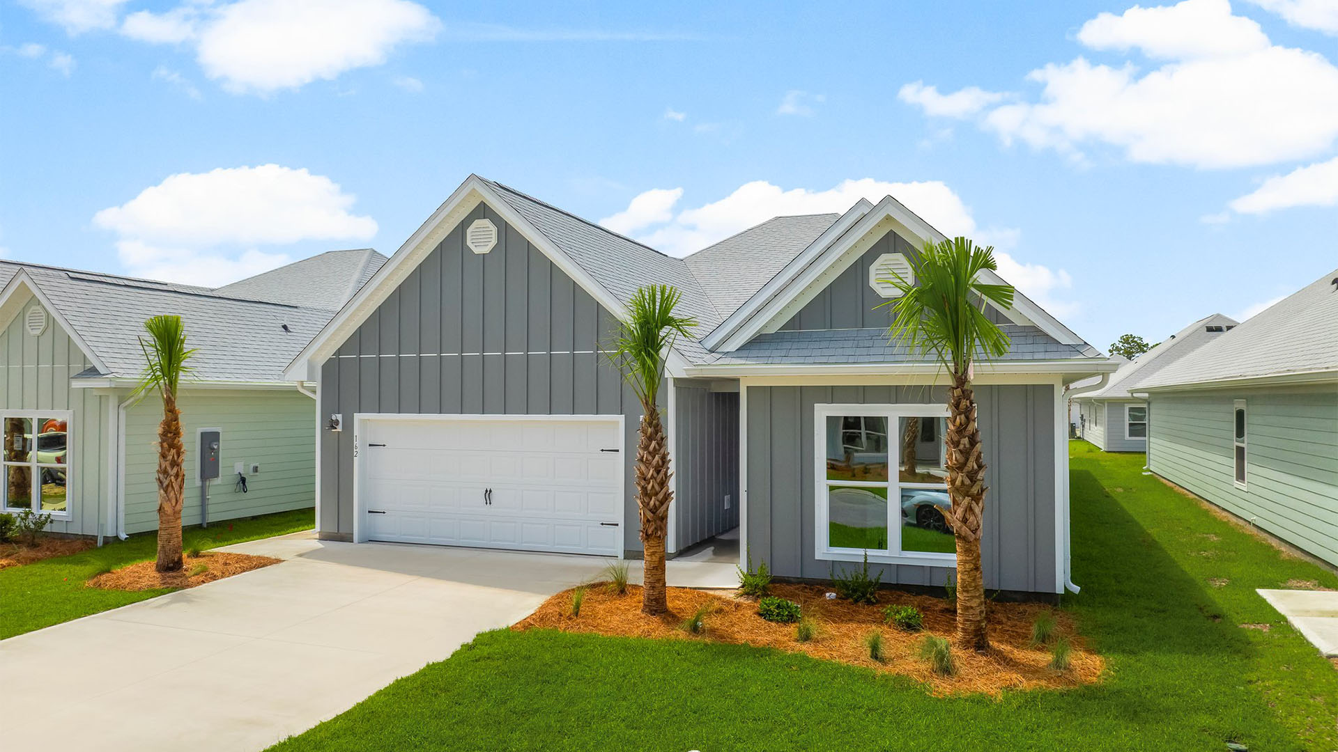 Kennedy floor plan at WindMark Beachfront of home with two-car garage and Hardie Board siding.