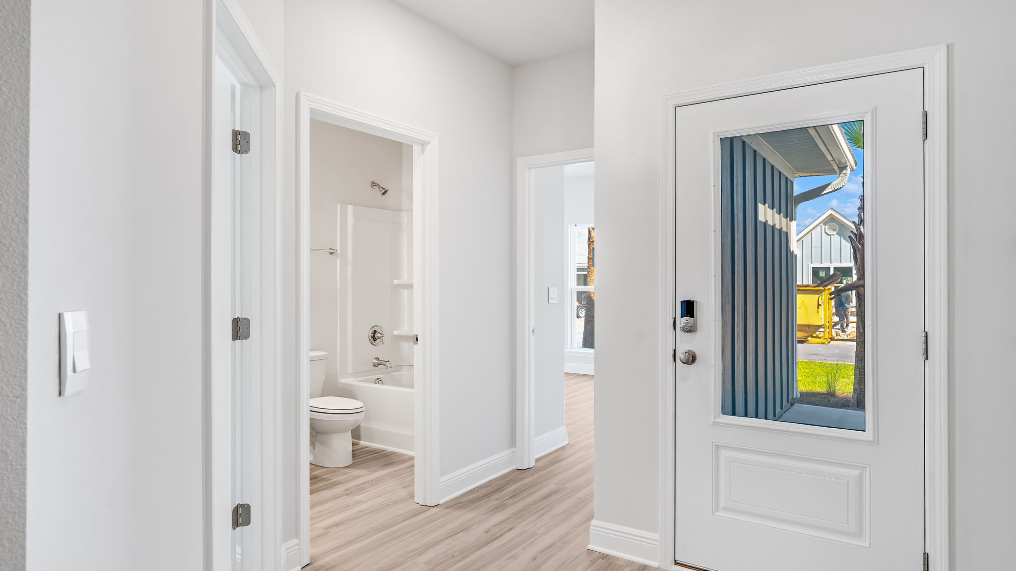 Front door entrance in foyer by bedroom and bathroom.