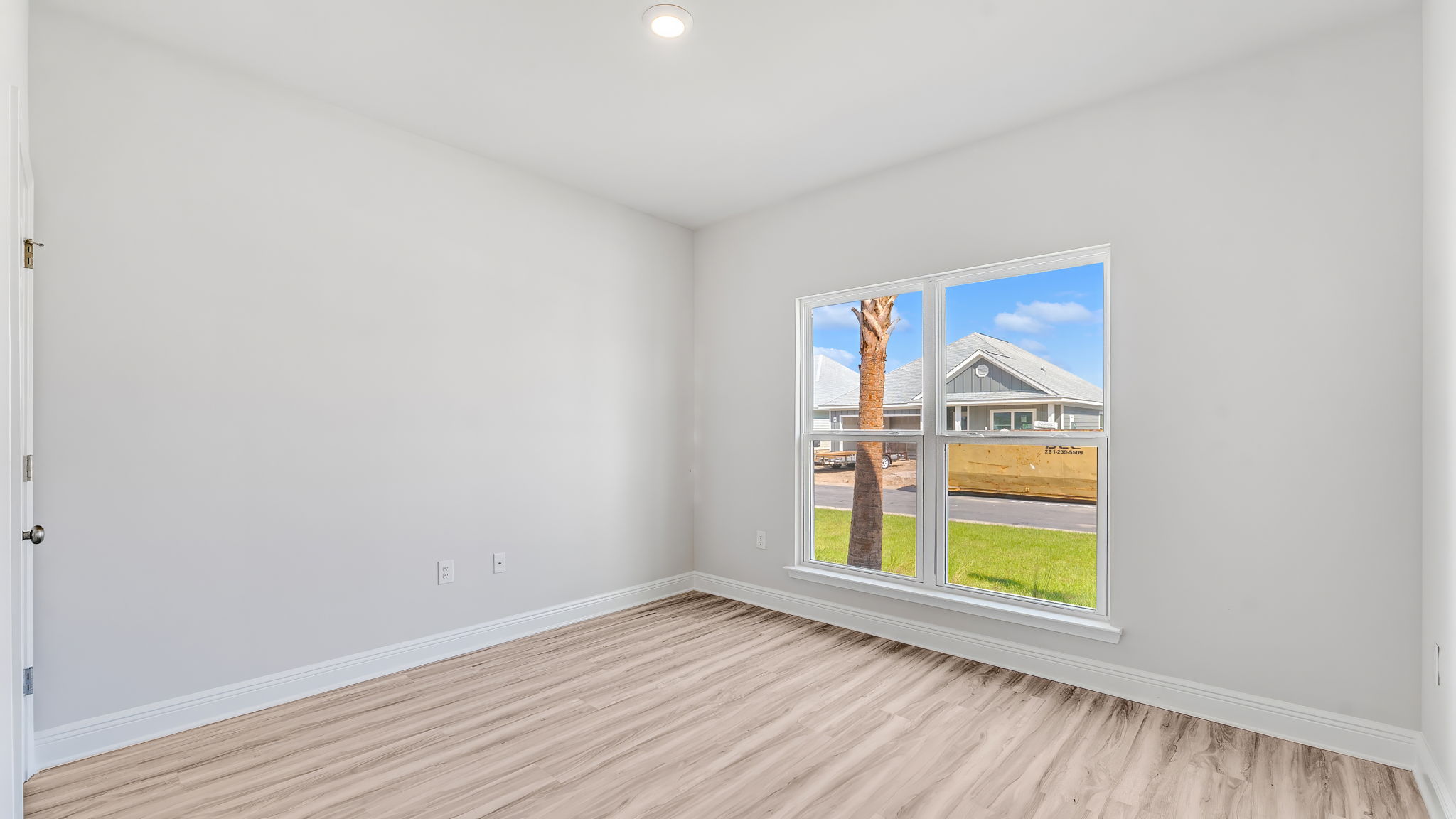 Bedroom with EVP flooring and window.
