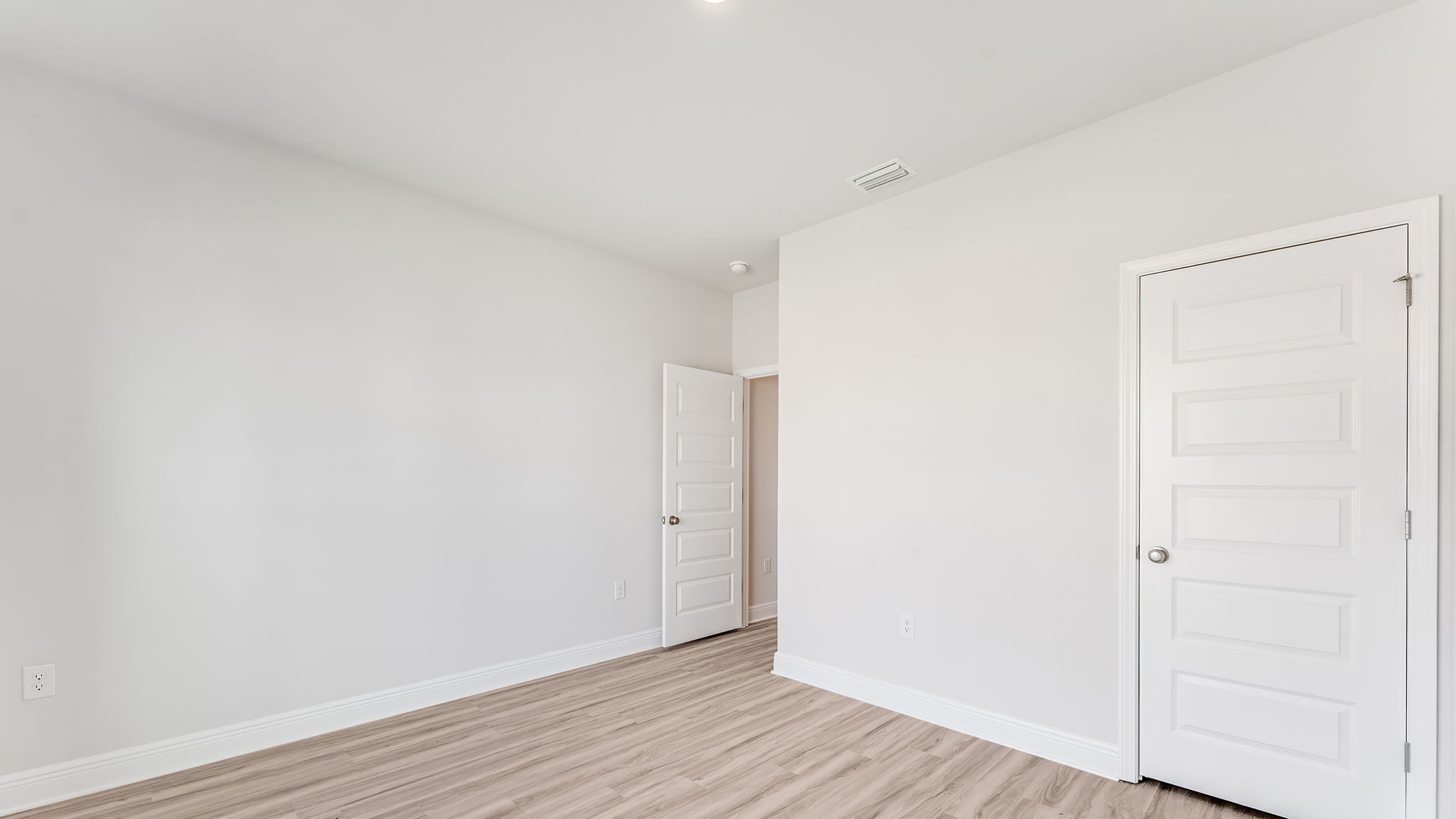 Bedroom with EVP flooring and closet.