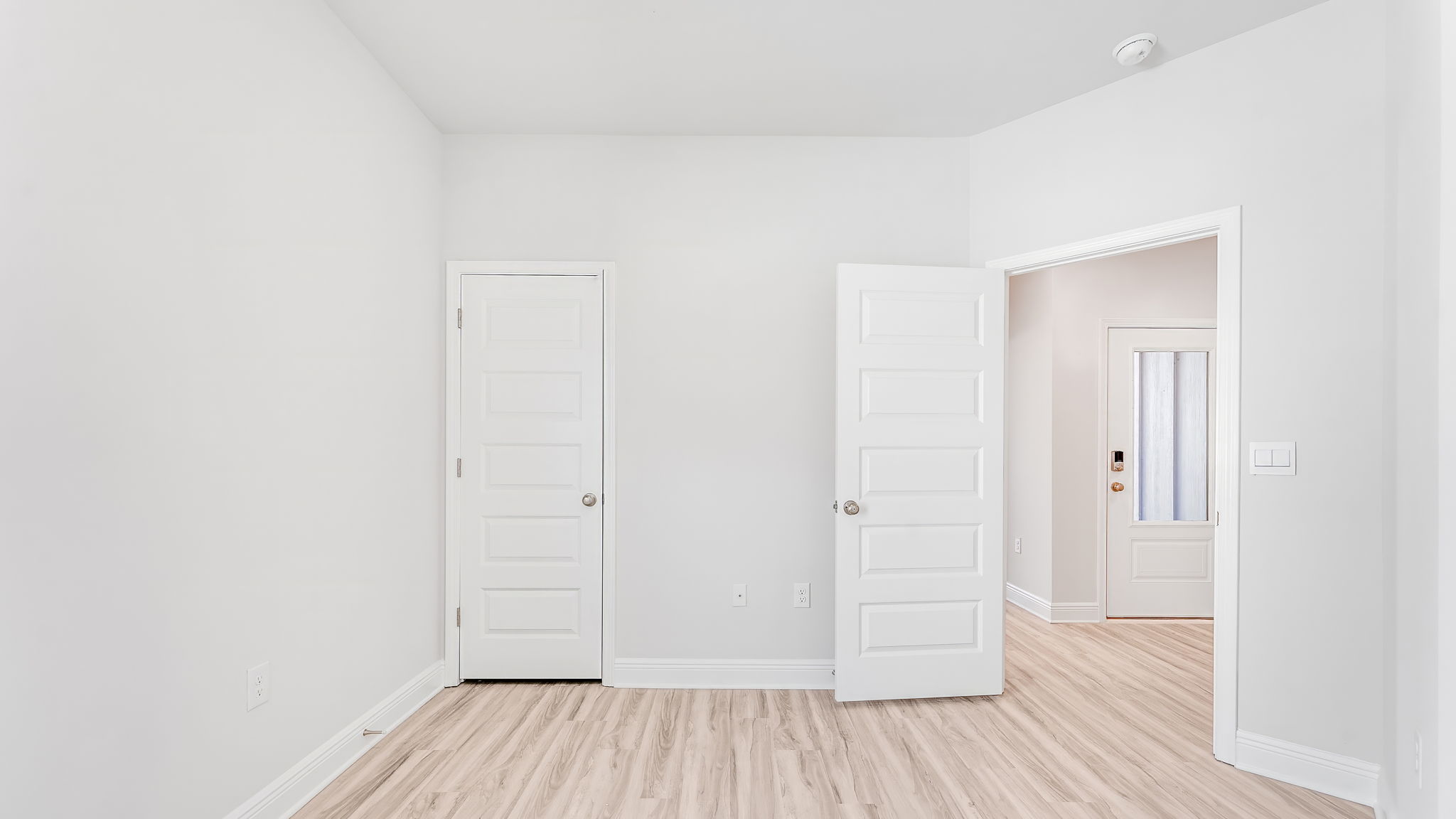 Bedroom with EVP flooring and closet.