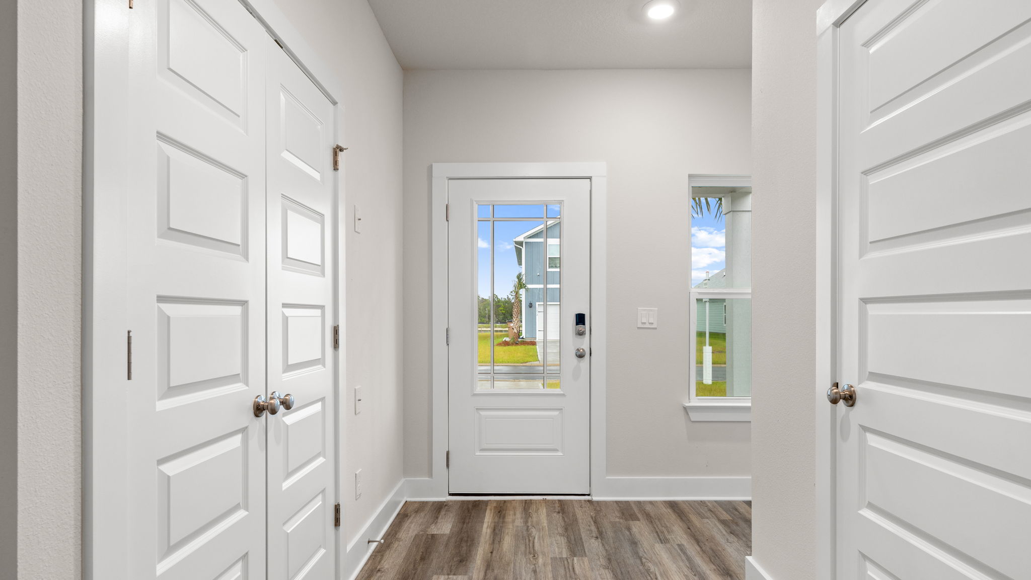Front foyer with EVP flooring and closet.