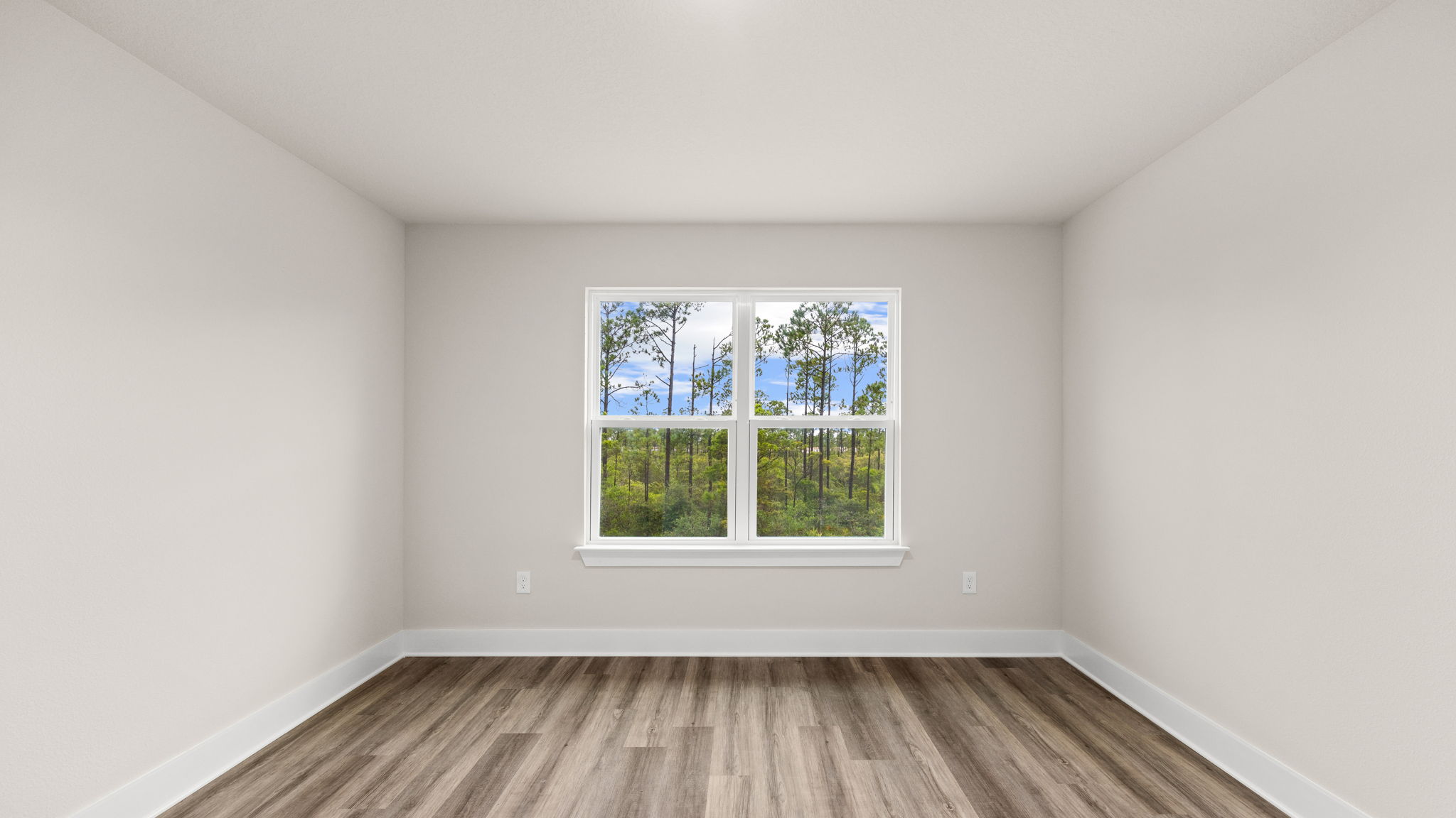 Bedroom with EVP flooring and window.